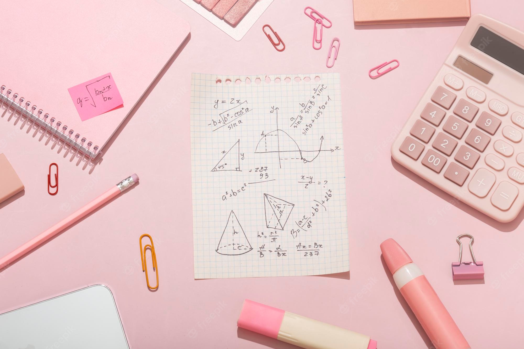 Premium Photo. On a pink background pink school supplies a calculator cheat sheets