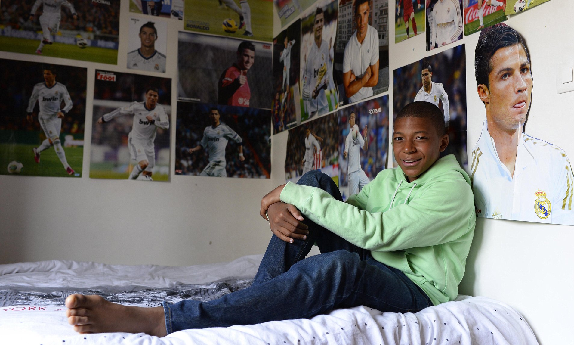 Kylian Mbappe covered walls in Cristiano Ronaldo picture. Daily Mail Online