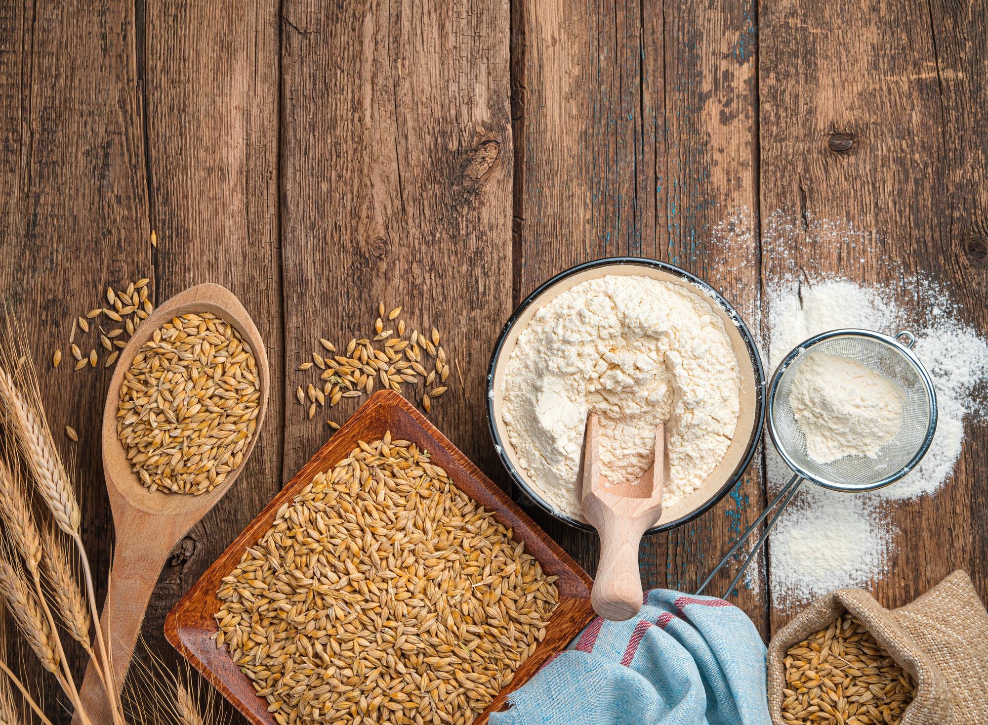 Premium Photo. Wheat flour and wheat on a brown background. top view, copy space