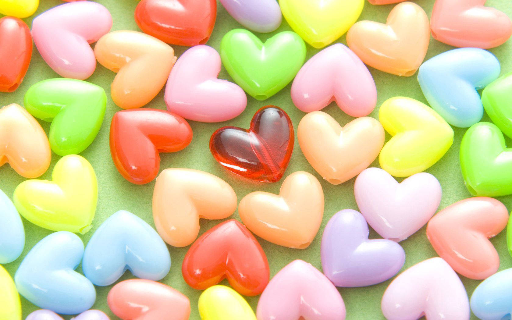 Download Colorful Hearts On Green Table Wallpaper