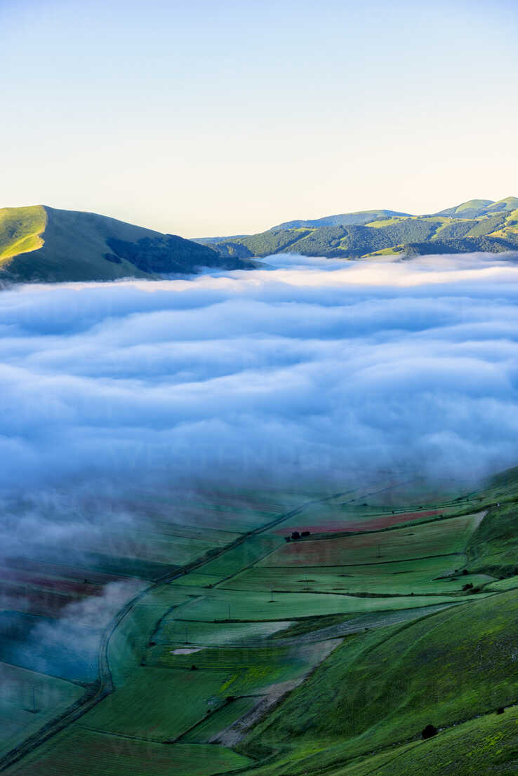 Italy, Umbria, Sibillini National Park, Piano Grande di Castelluccio di Norcia in the morning, fog stock