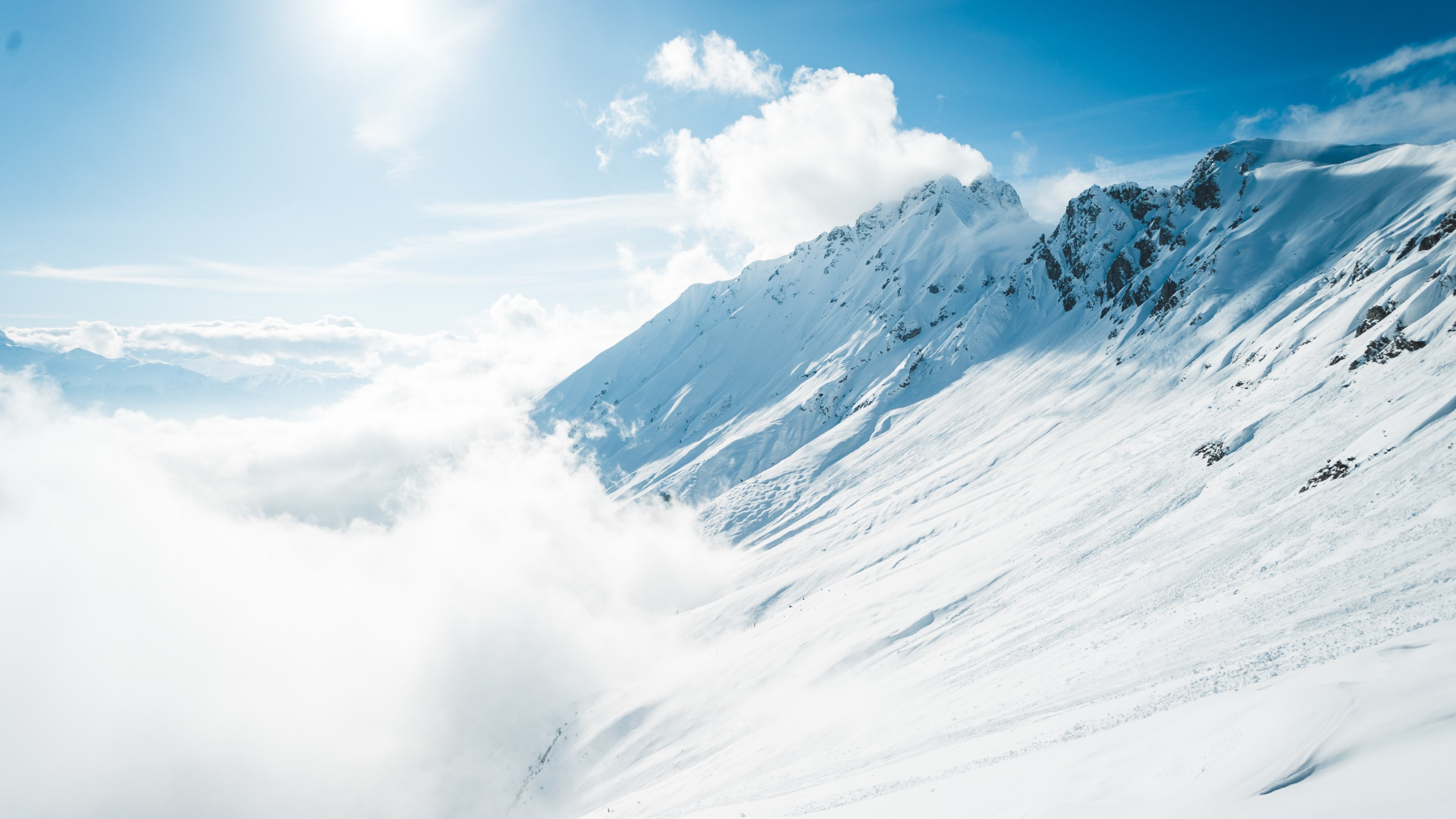 Download wallpaper: Mountains full of snow and blue sky 2560x1440