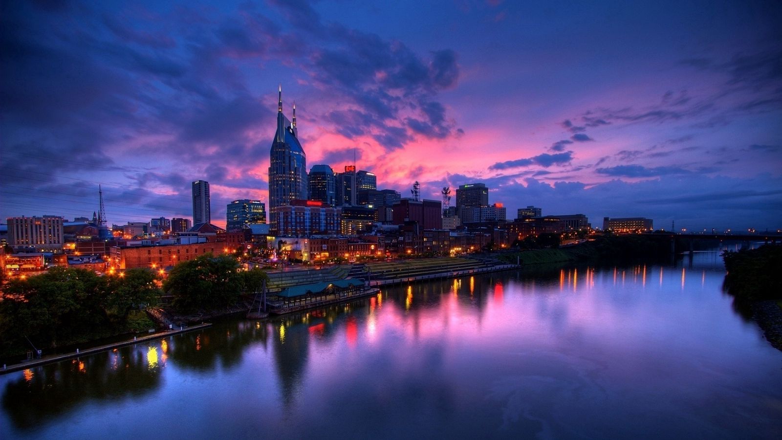 Download wallpaper 1600x900 purple sunset, city, buildings, skyscrapers, beach, night, river widescreen 16:9 HD background