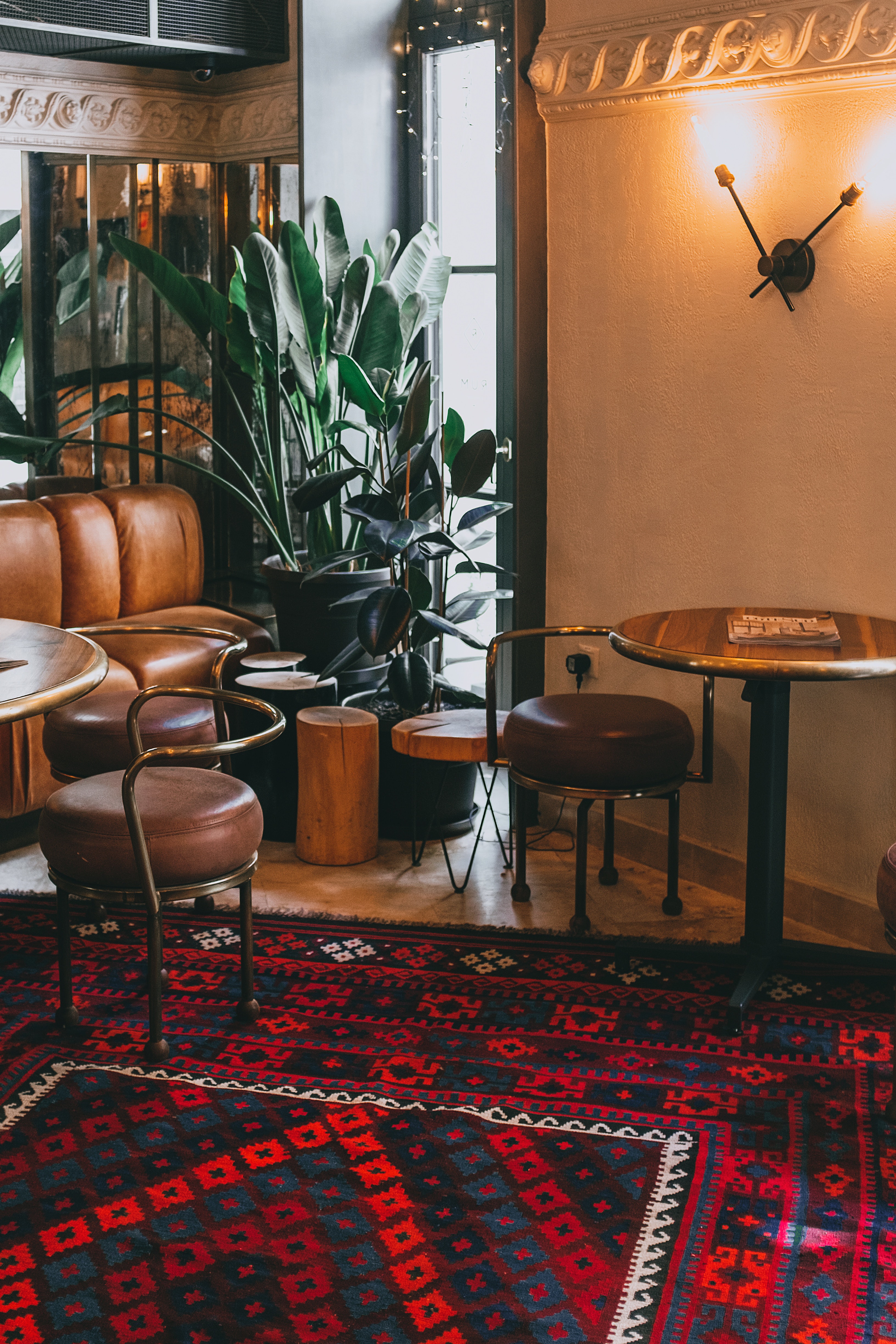 Interior of cozy cafe with couch and round table · Free