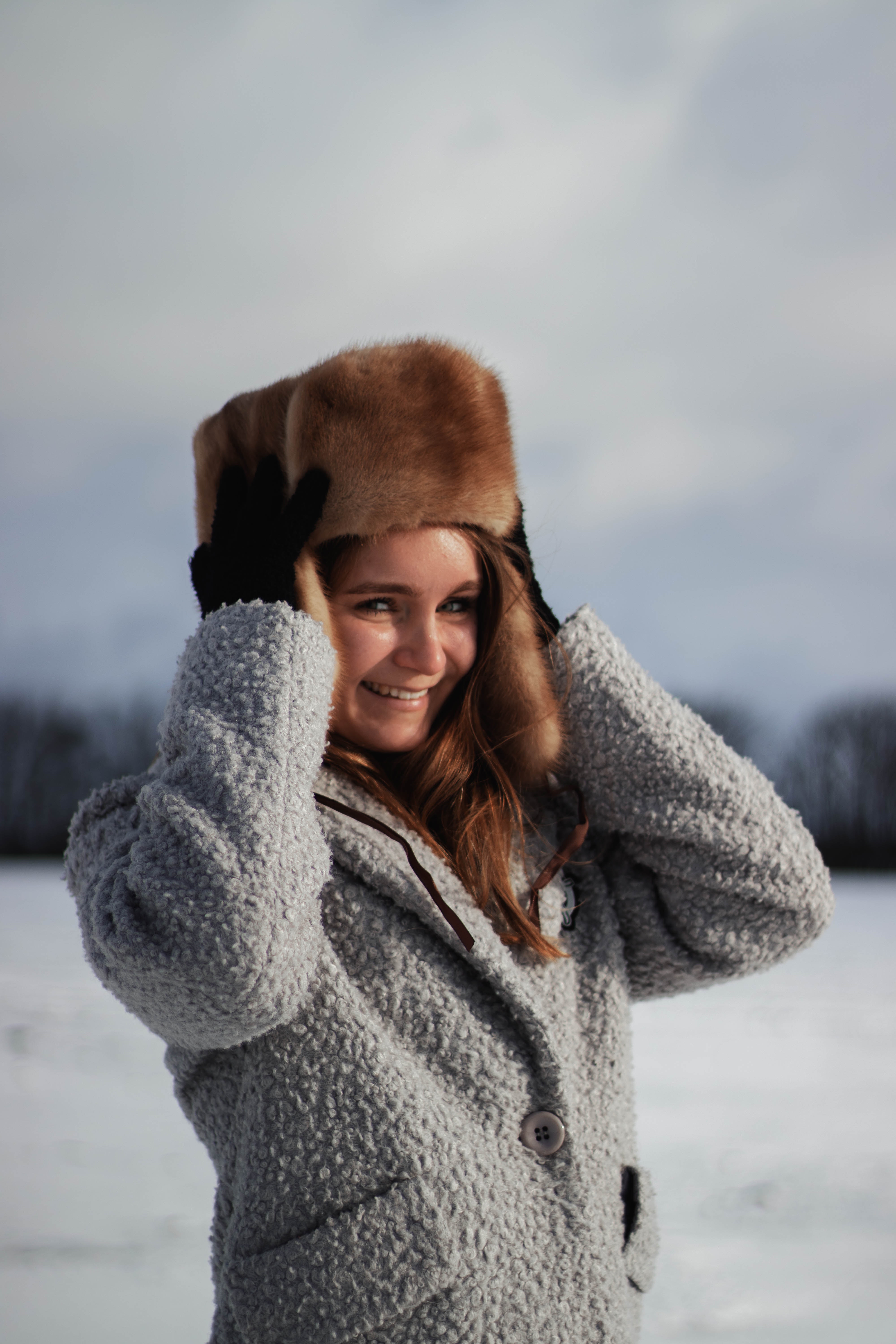 A Beautiful Woman Wearing an Ushanka Hat · Free