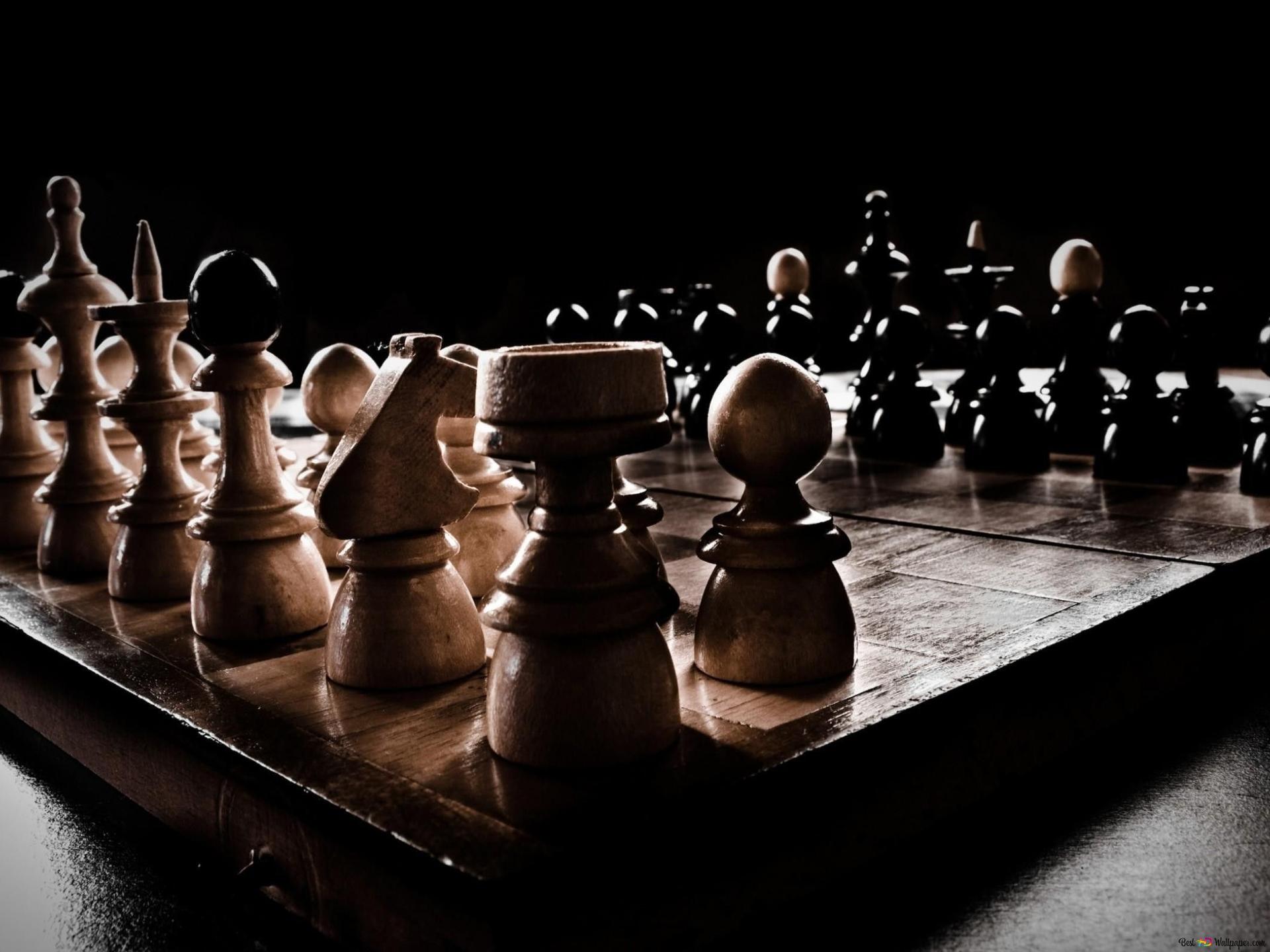Wooden chipped chess pieces on wooden chessboard 2K wallpaper download
