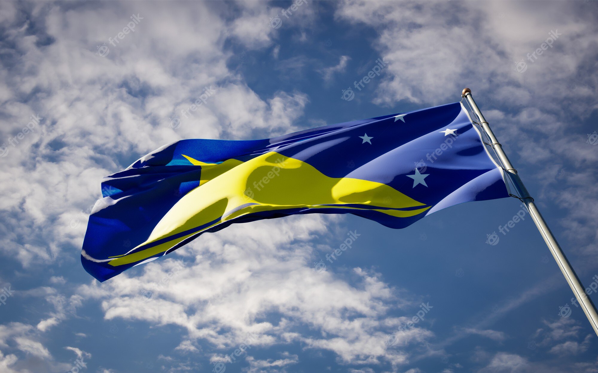 Premium Photo. Beautiful national state flag of tokelau fluttering on blue sky