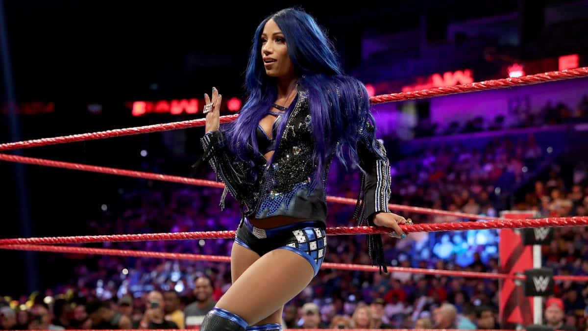 Download Sasha Banks Posing On The Ring Ropes Wallpaper