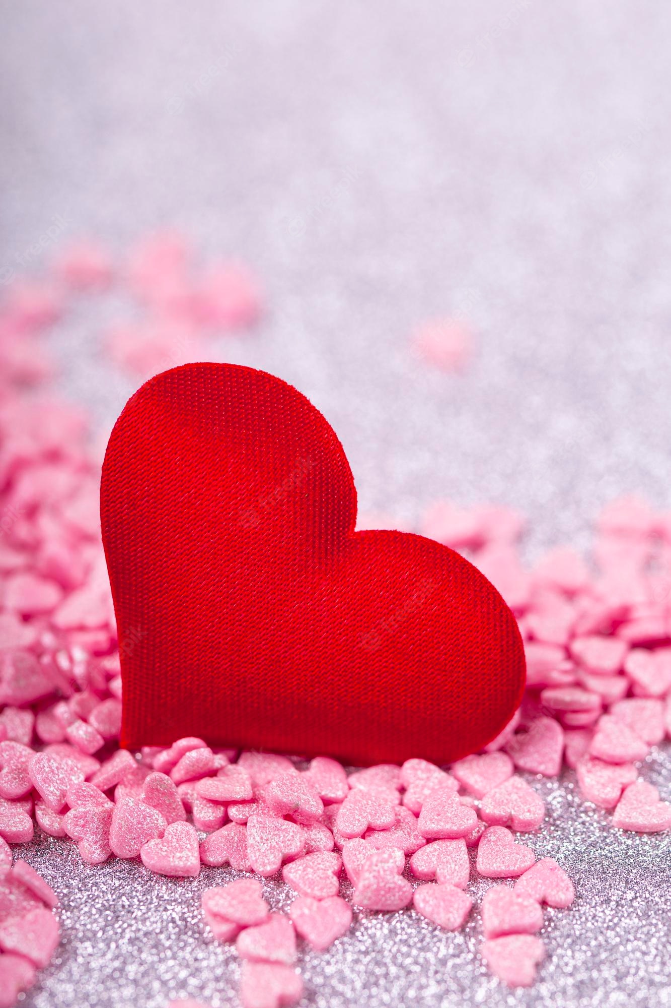 Premium Photo. Valentines day vertical festive card with red and pink hearts on a light gray background copy space