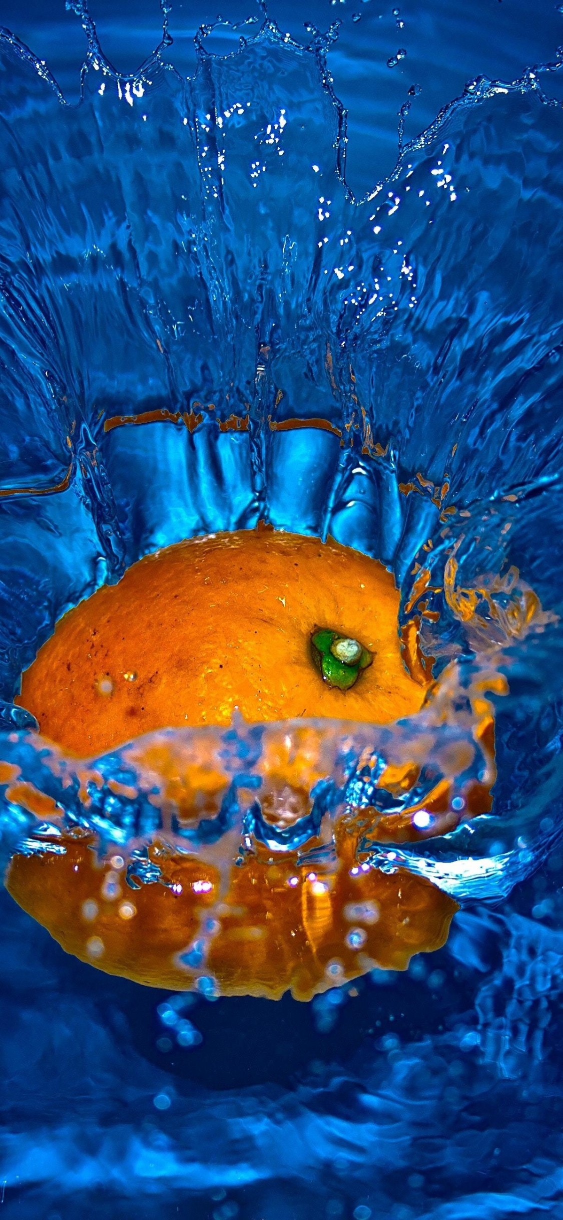 Download wallpaper 1125x2436 orange fruit, splashes, water, iphone x, 1125x2436 HD background, 21678