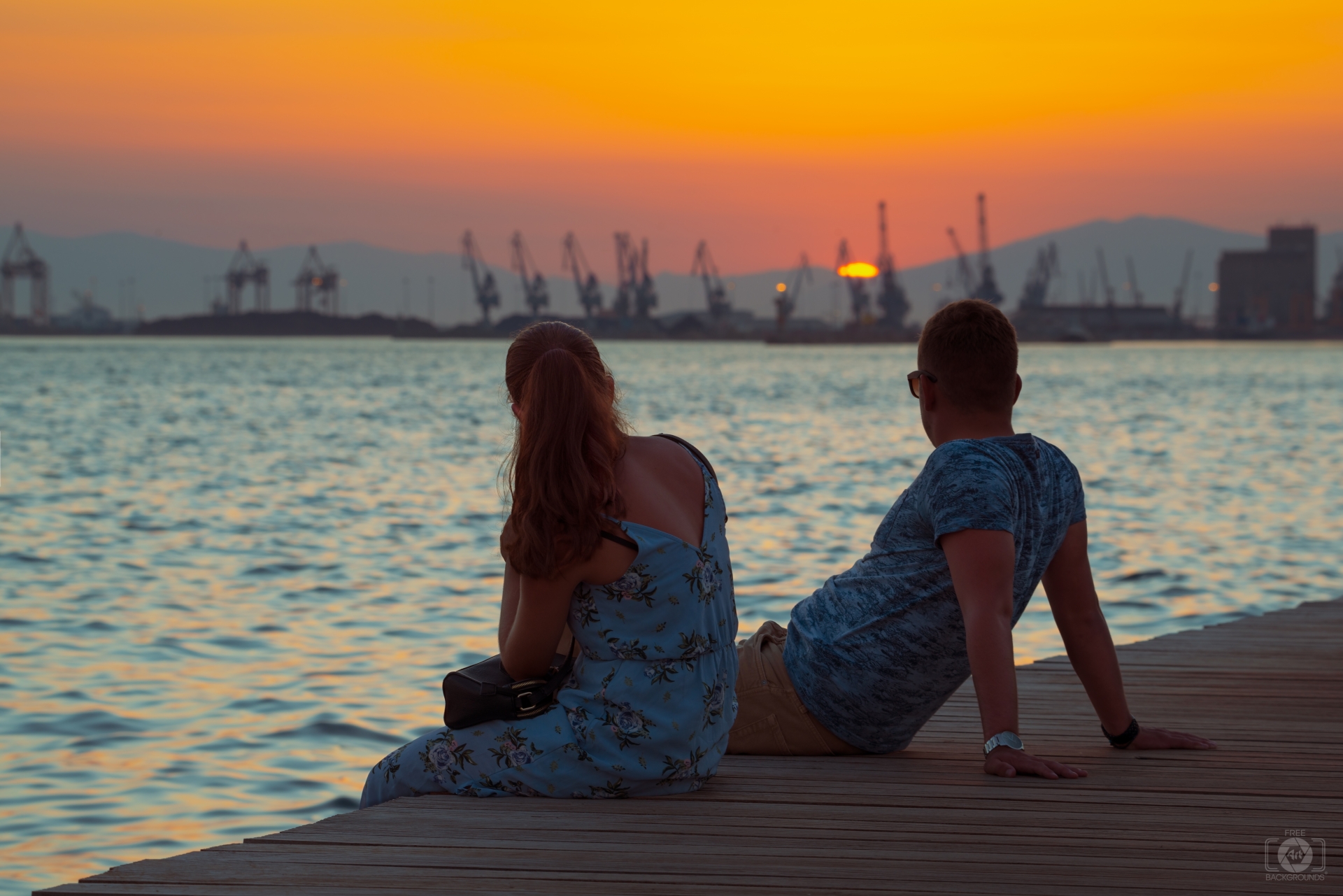 Romantic Couple Sitting On The Pier At Sunset Quality Free Background