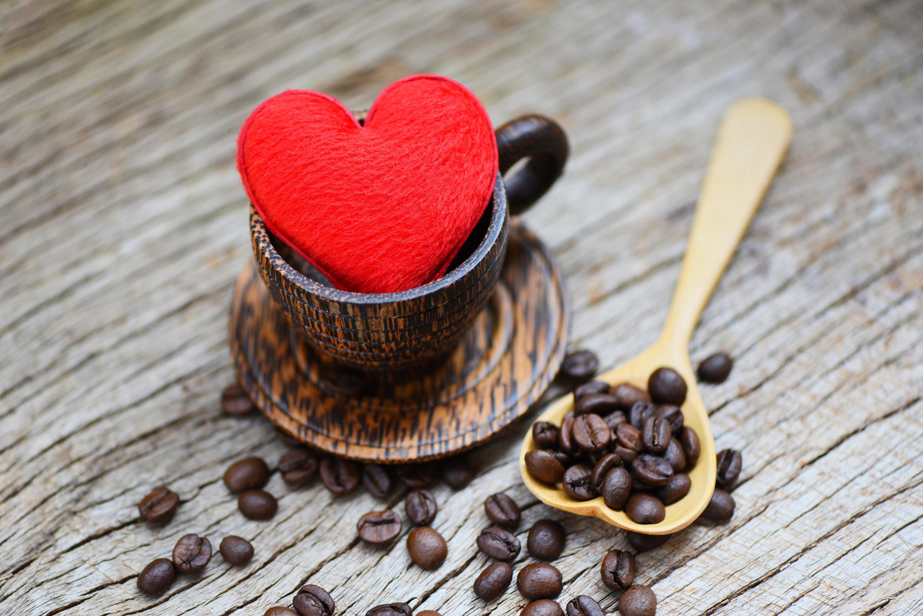 Love coffee concept in wooden coffee cup with coffee beans romantic love valentines day on wood background