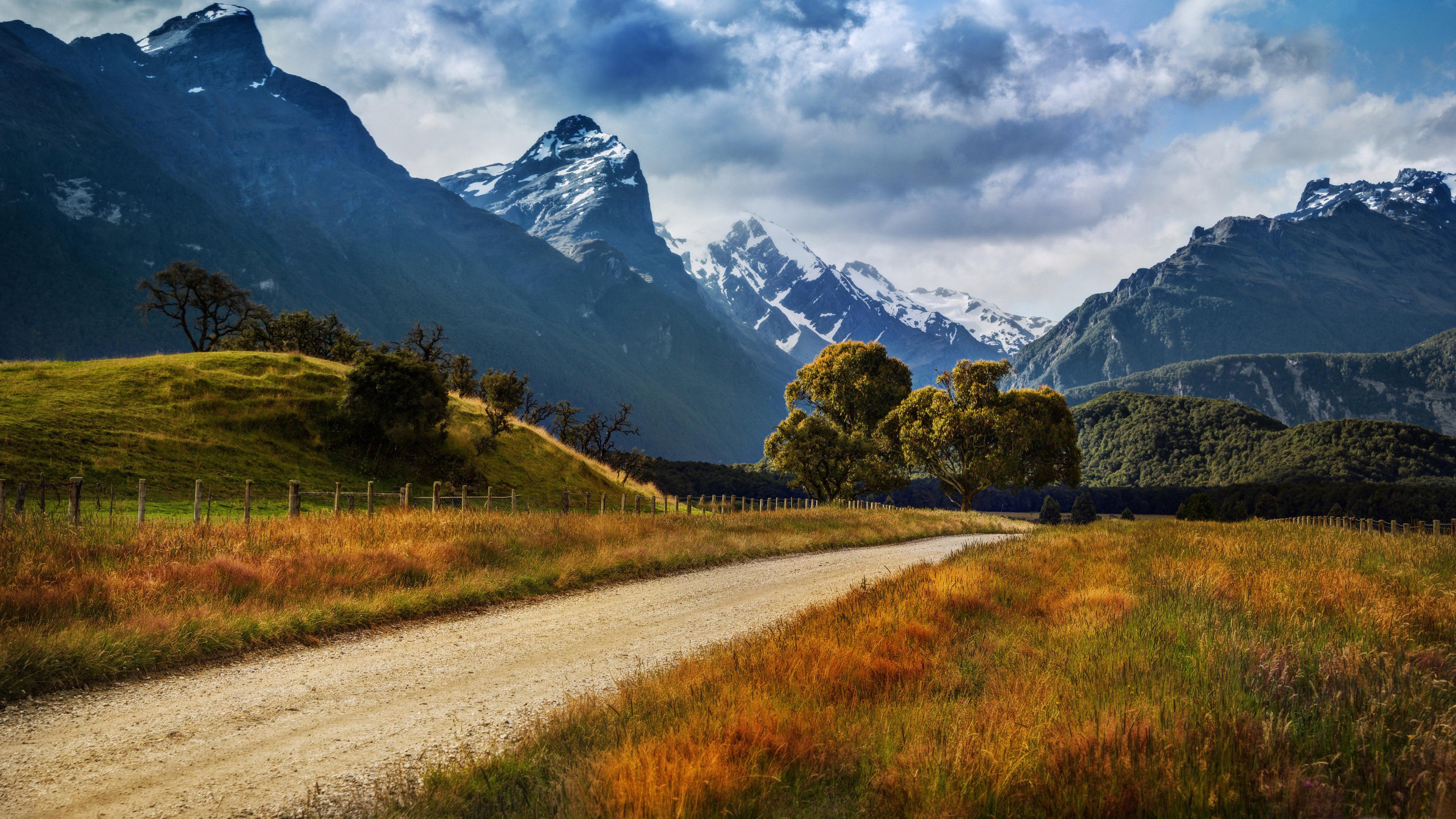 Landscape Of New Zealand Country Road Yellowed Grass, Rocky Peaks Of Mountains With Snow, Dark Clouds Desktop Wallpaper Full Screen, Wallpaper13.com