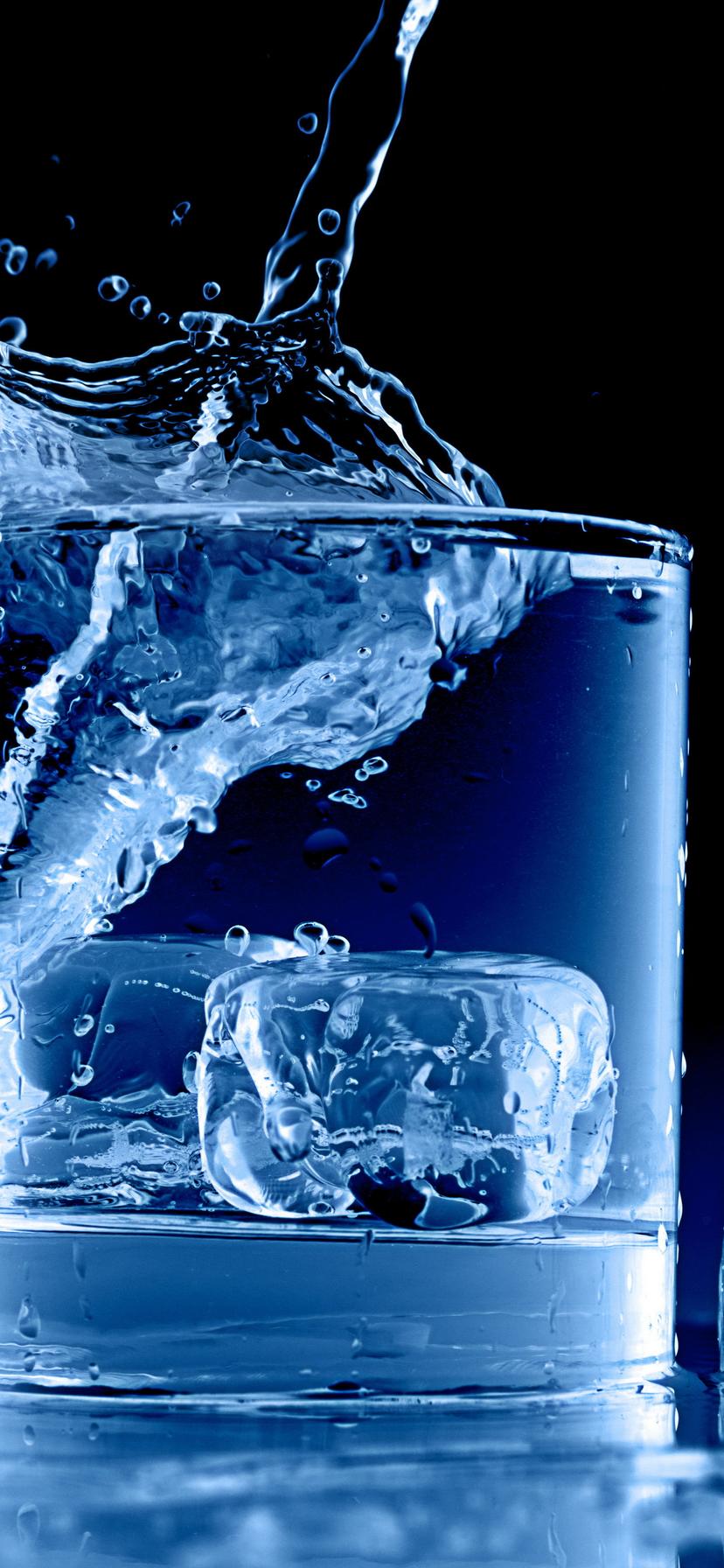 Water in a glass full with ice cubes