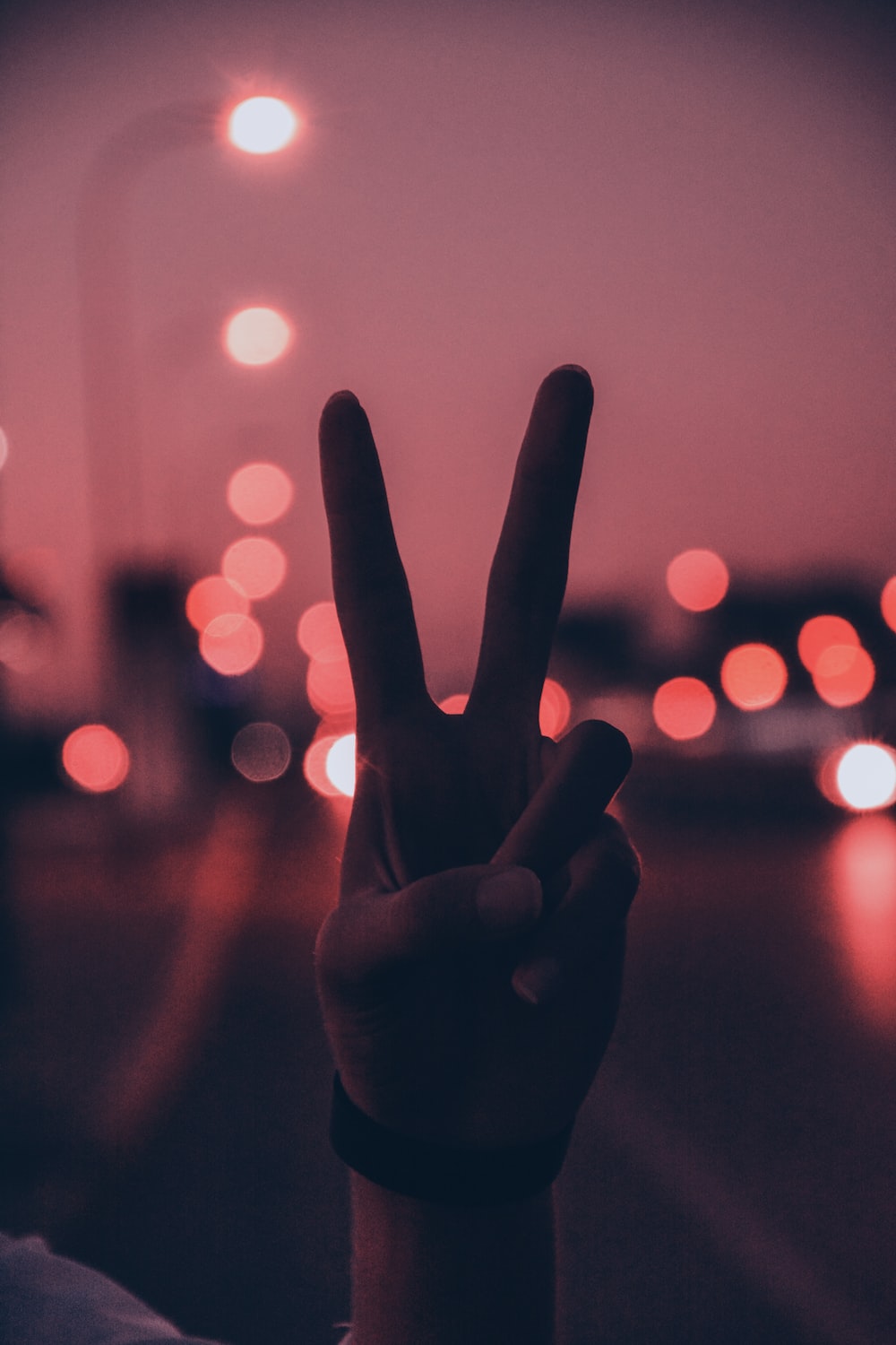 person doing peace sign hand gesture photo