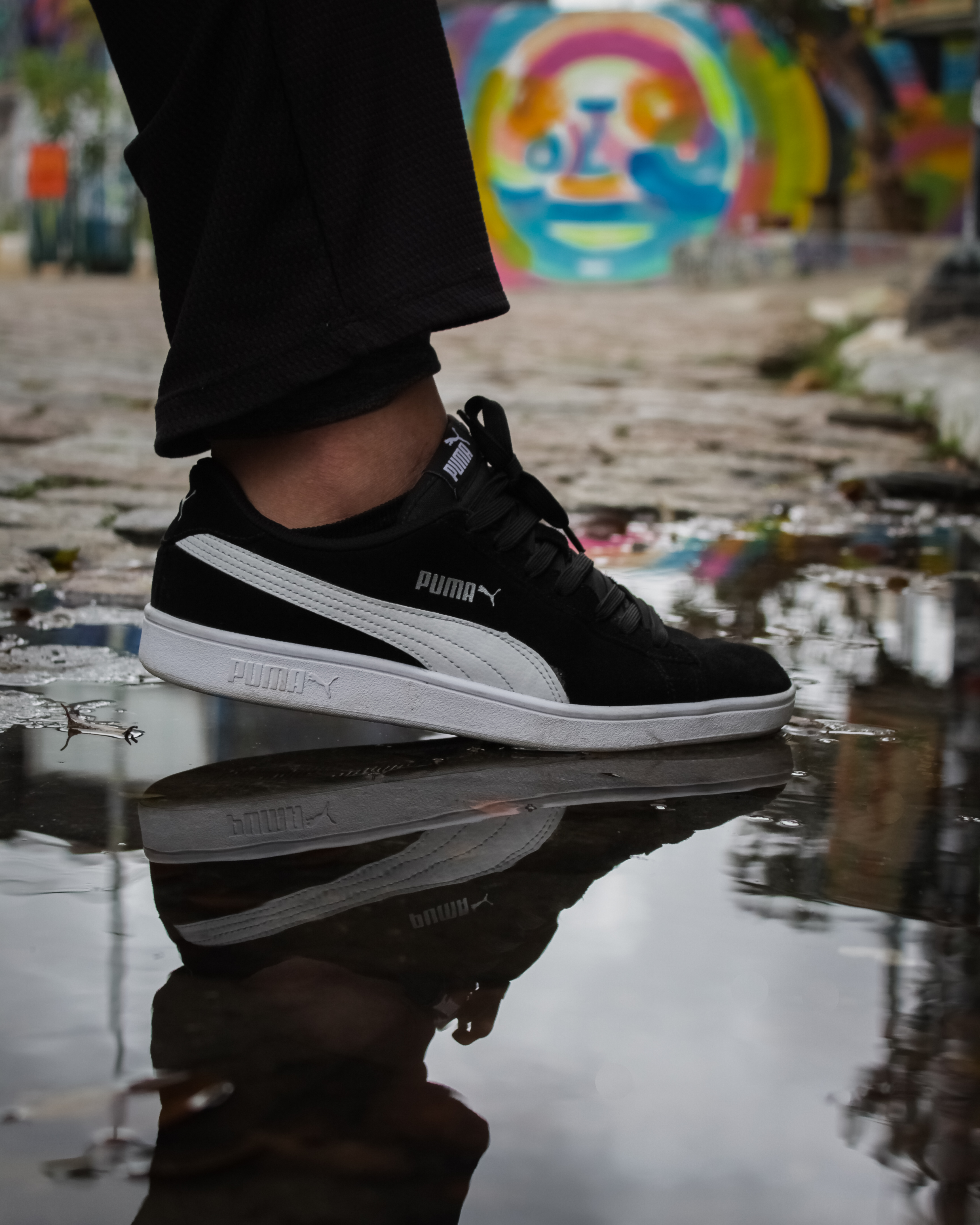 A Person in White and Black Puma Suede Shoe · Free