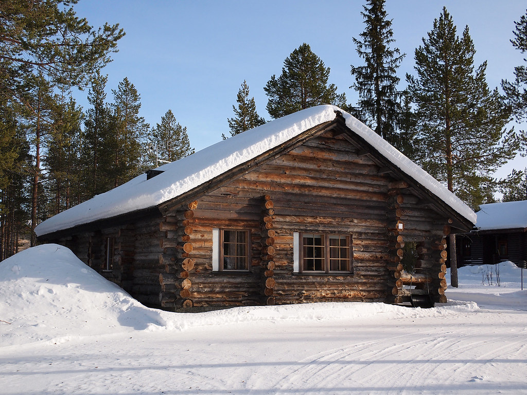 Lapland log cabin. Romantic snow covered log cabin between