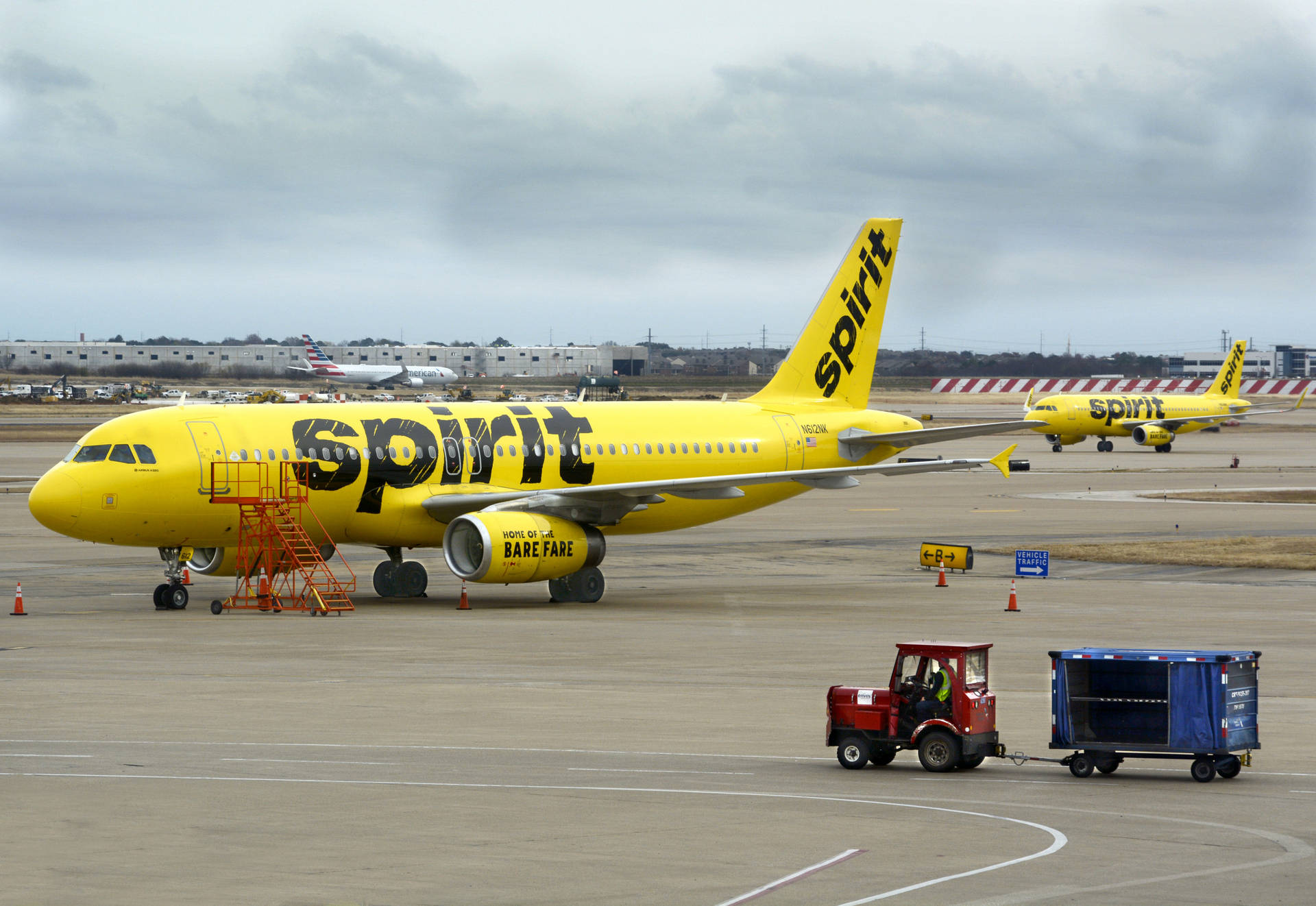 Download Spirit Airlines Plane And Airport Tractor Wallpaper