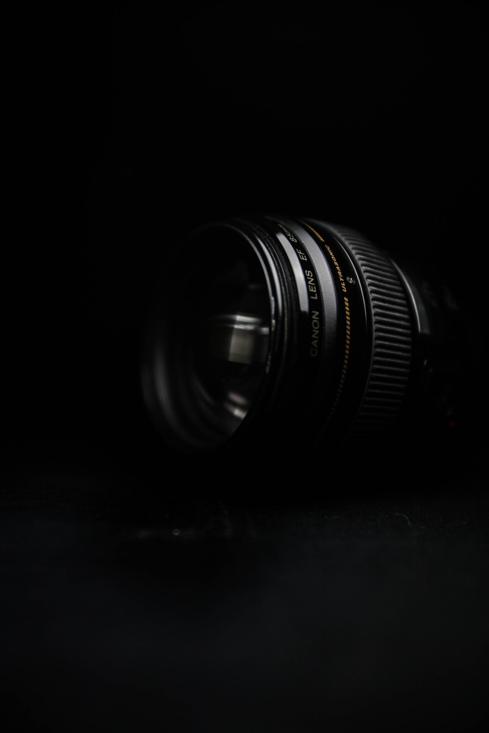 black camera lens on black surface photo