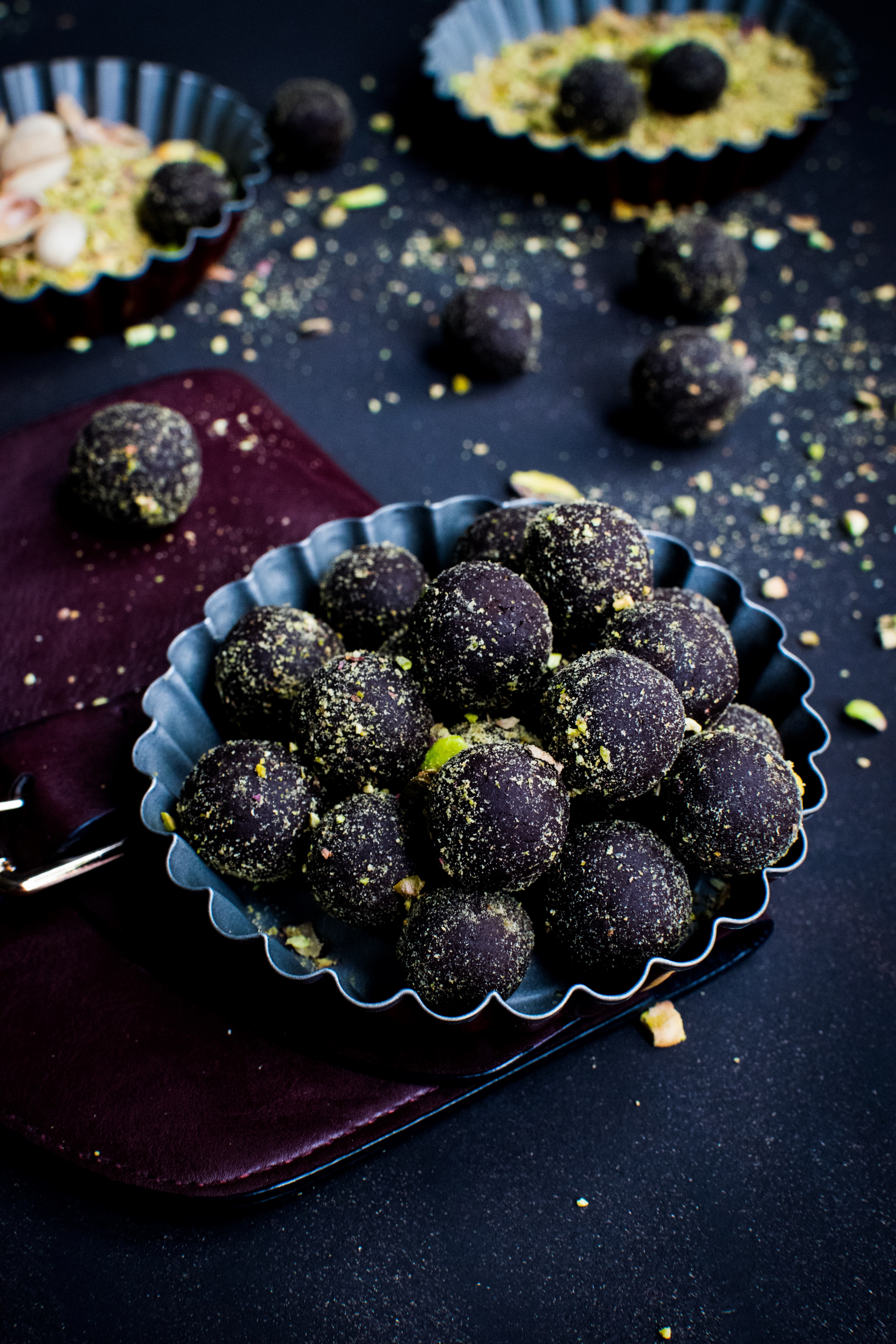 Wallpaper / rustic bowls of dark chocolate truffle dessert rolled in pistachios, dark chocolate pralines with pistachios 4k wallpaper free download
