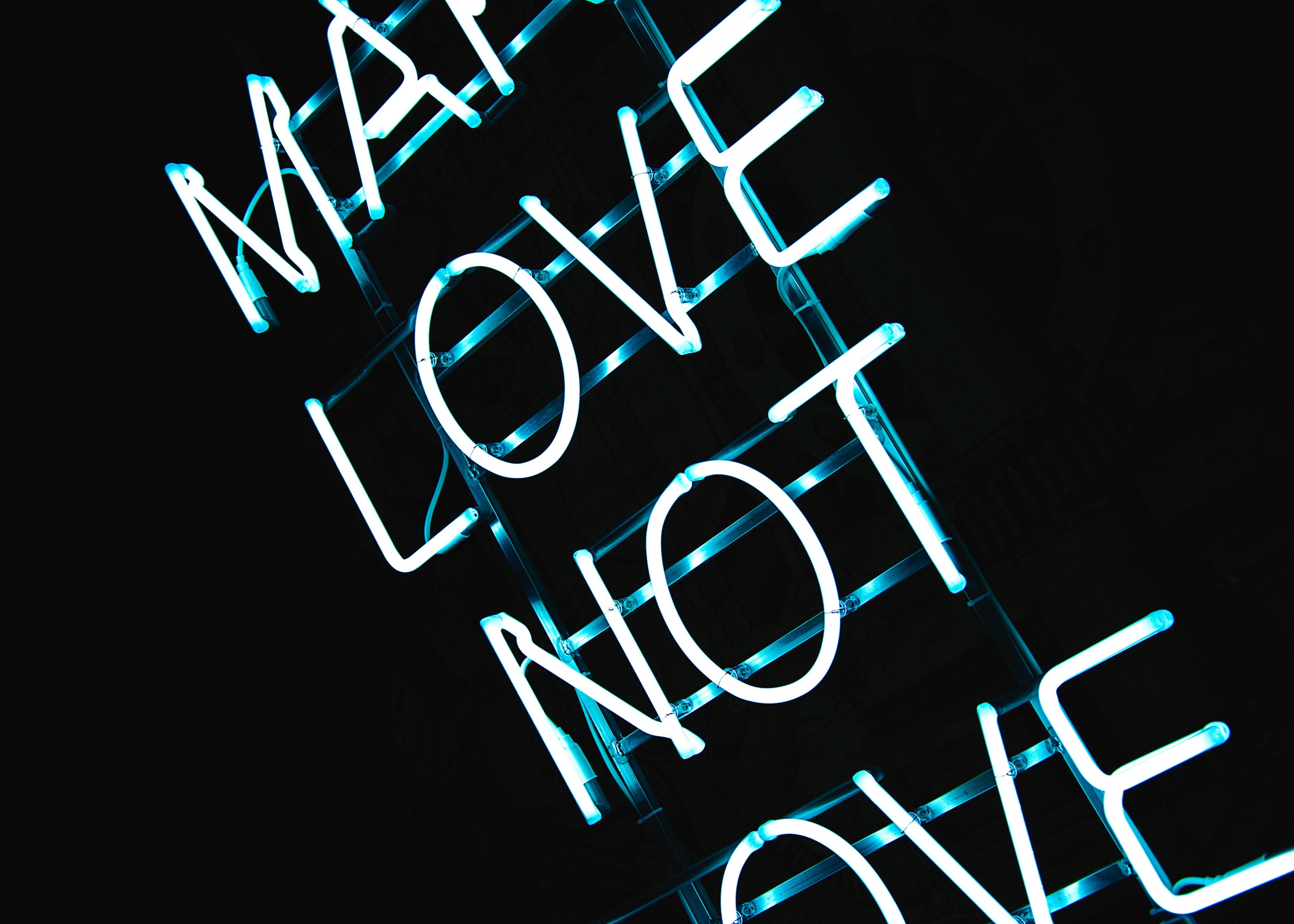 Wallpaper / blue neon light sign on black background reads make love not love, make love neon sign 4k wallpaper free download
