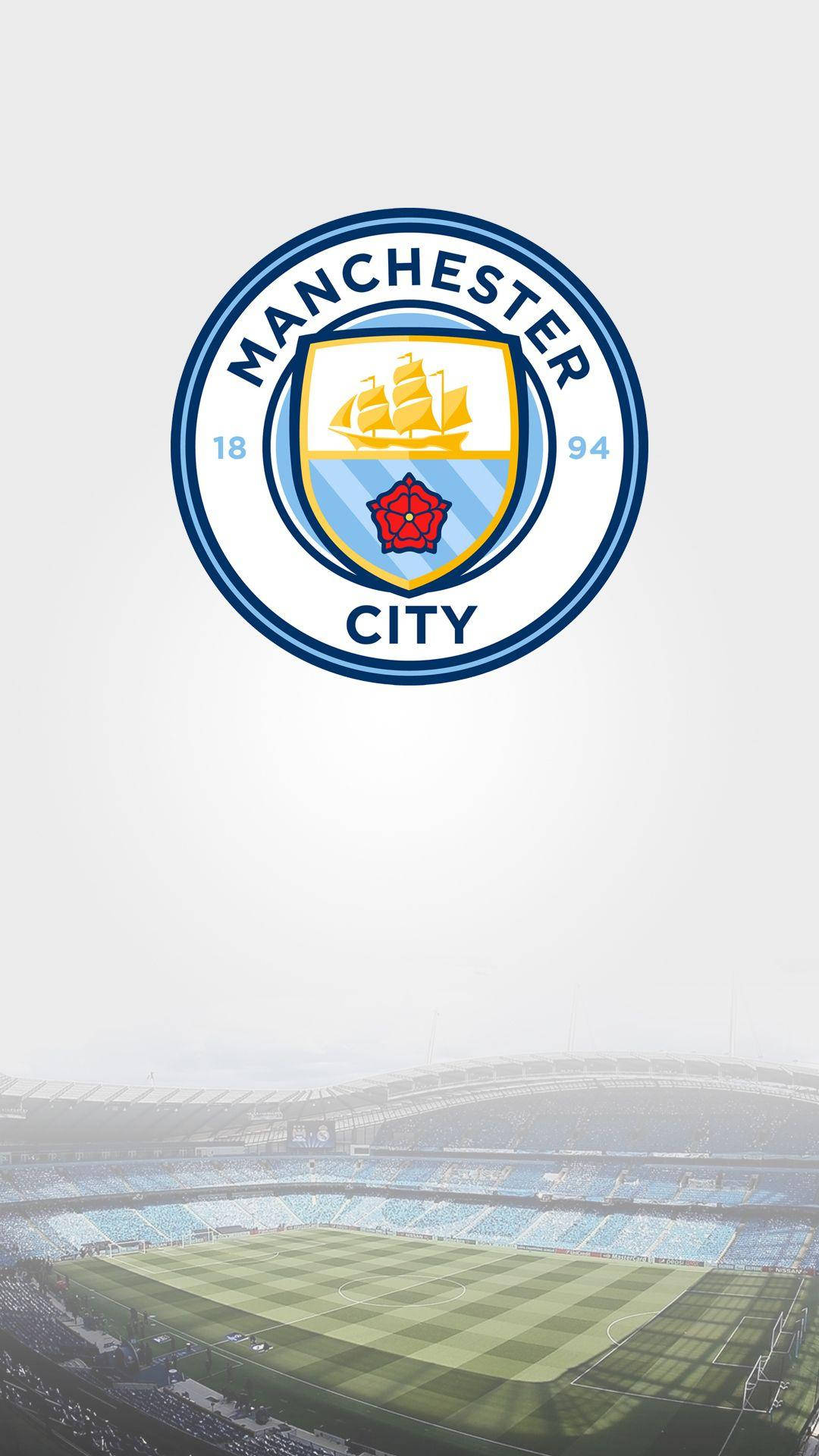 Download Etihad Stadium With The Manchester City Logo Wallpaper