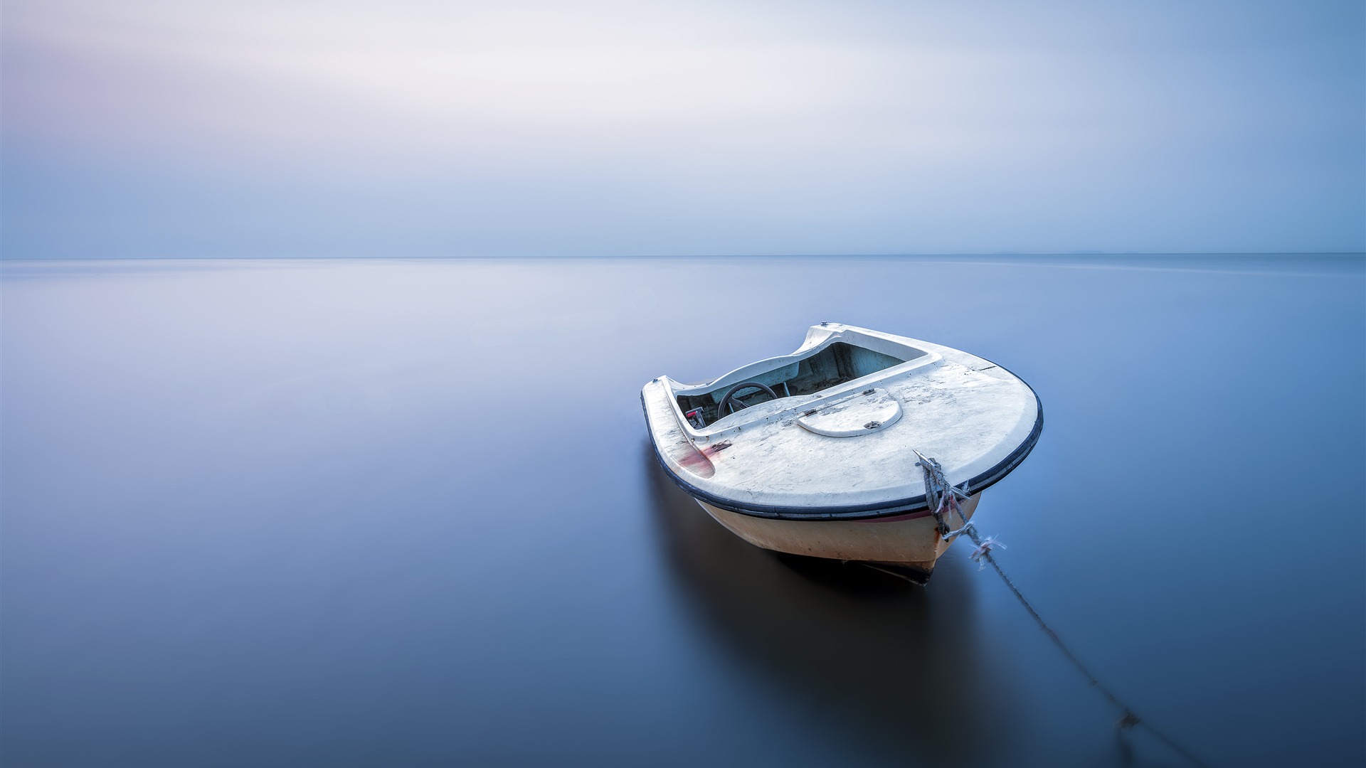 Early morning tranquil lake boat horizon