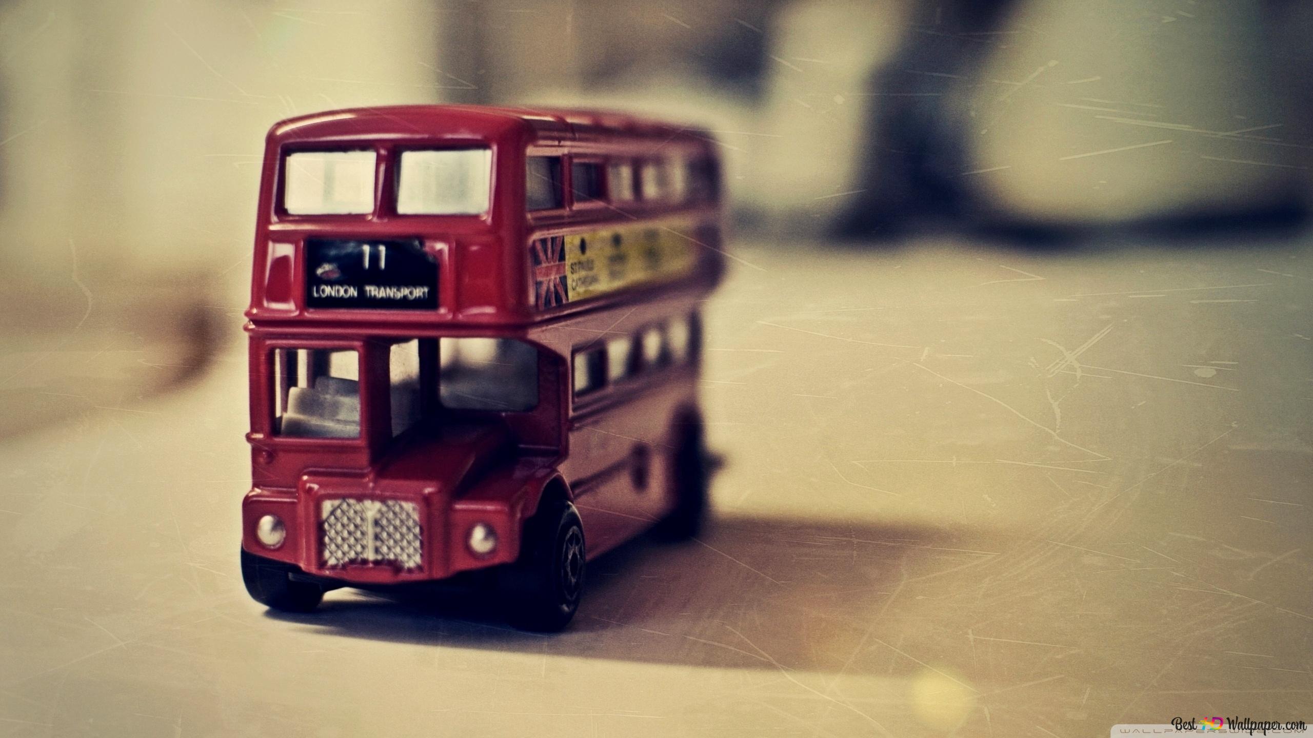 Red Double Decker Vintage Bus In Front Of Blurred Background 2K Wallpaper Download