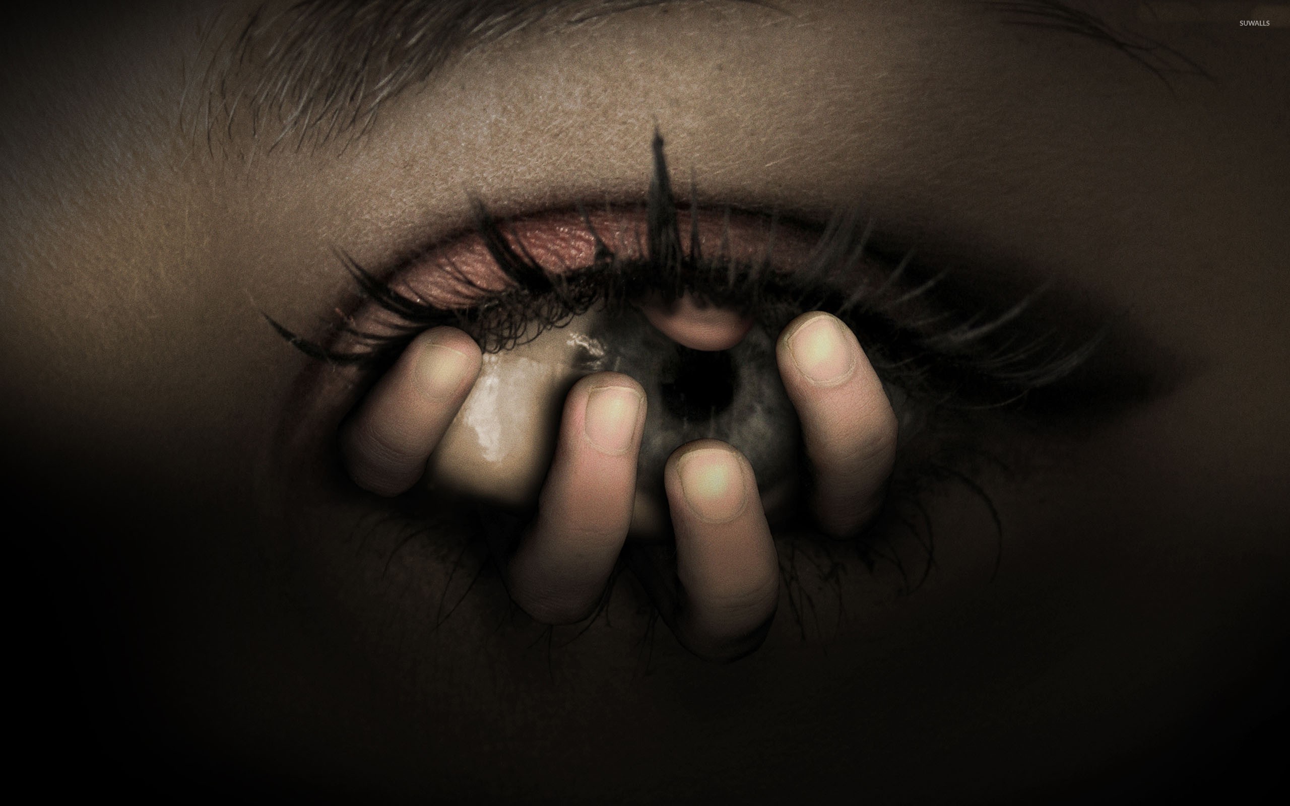 Fingers holding the eye wallpaper Art wallpaper