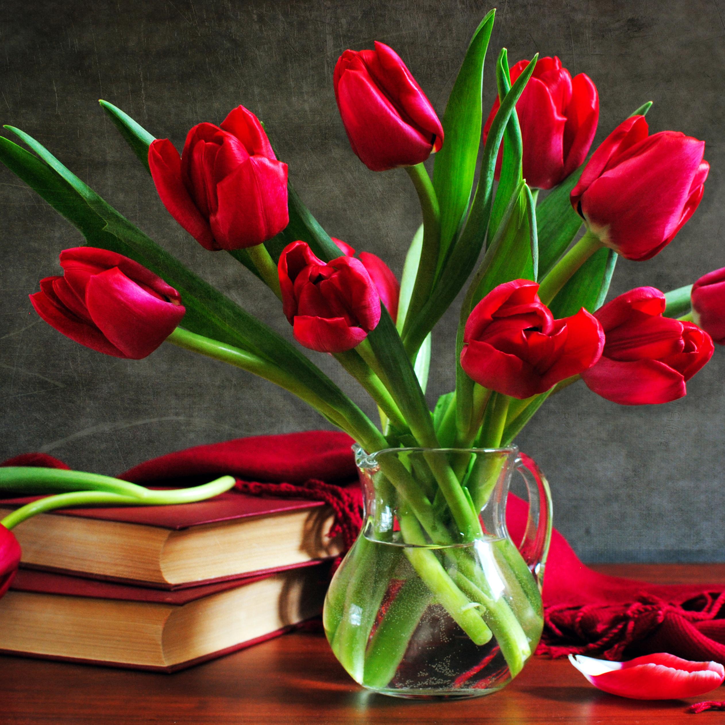 Red books and wonderful bouquet of red tulips