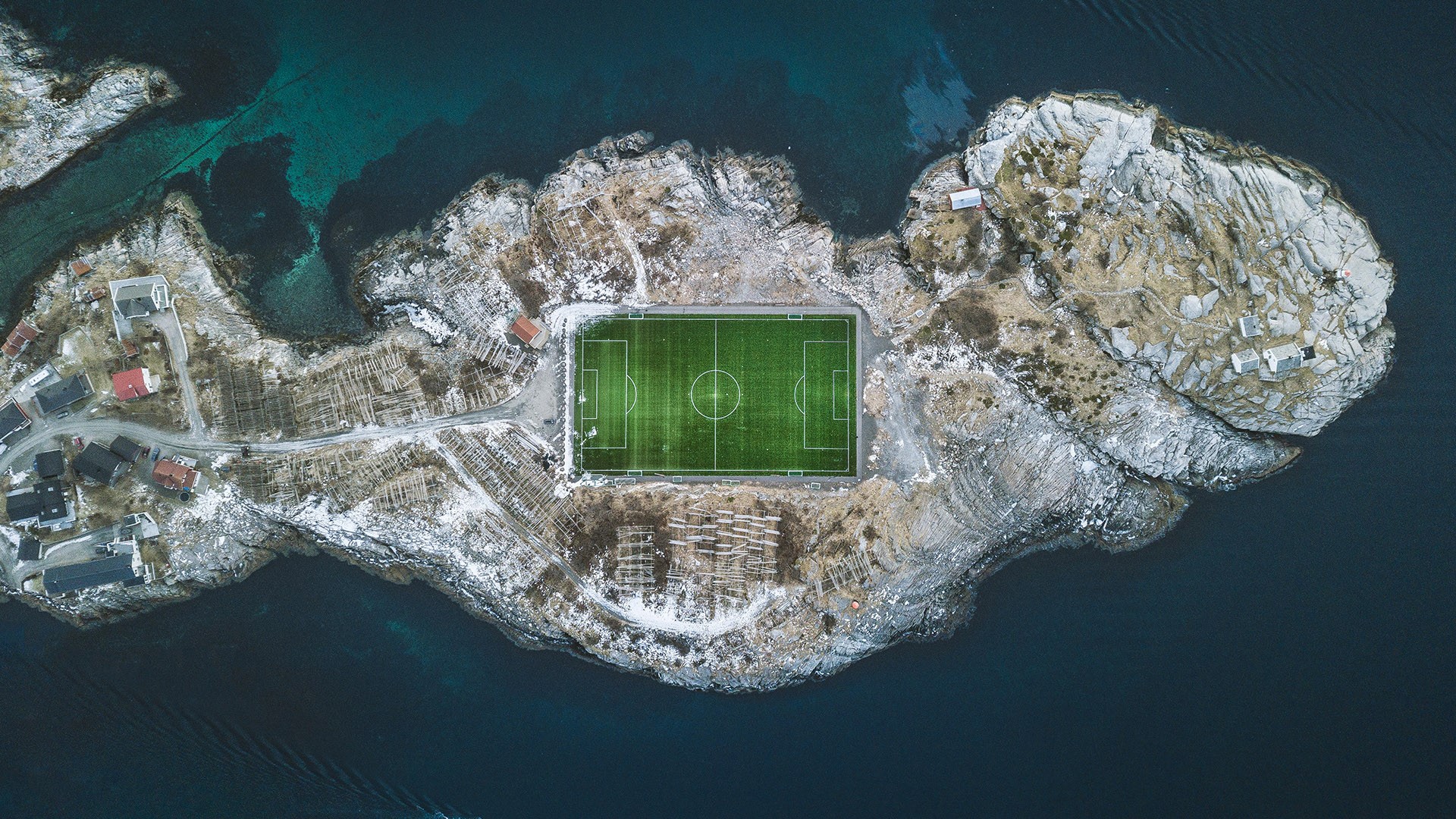 Aerial view of Henningsvær football stadium at the Atlantic Ocean, Lofoten Islands, Norway. Windows 10 Spotlight Image