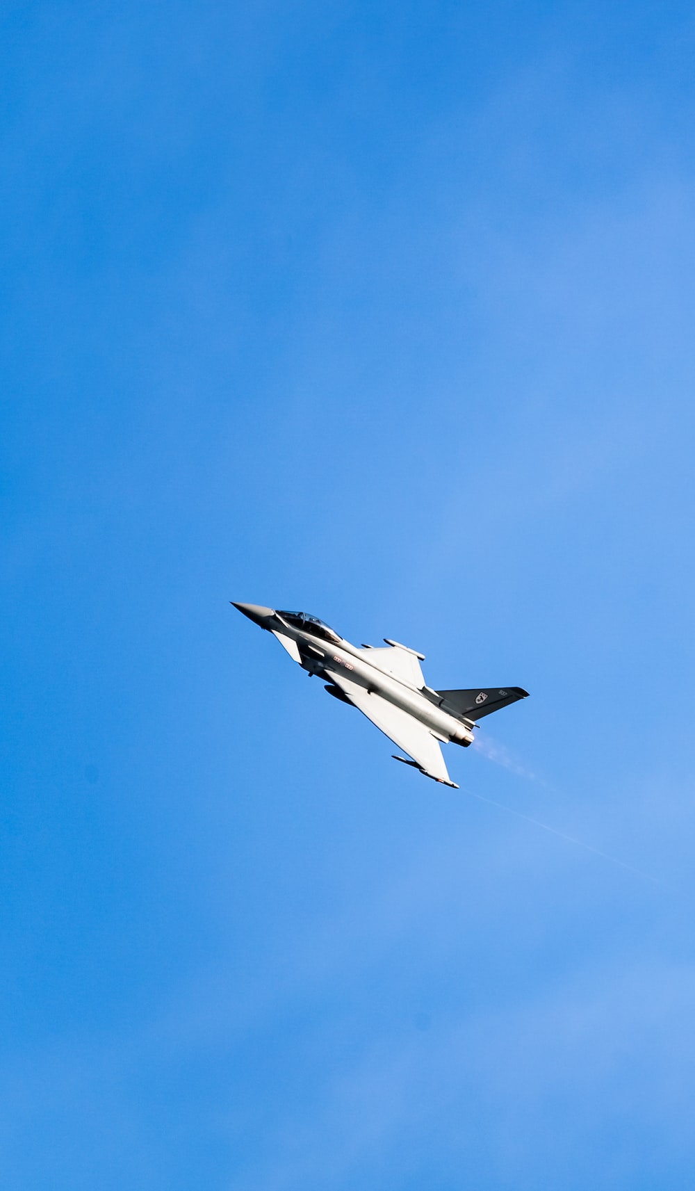 white and black jet plane in mid air during daytime photo