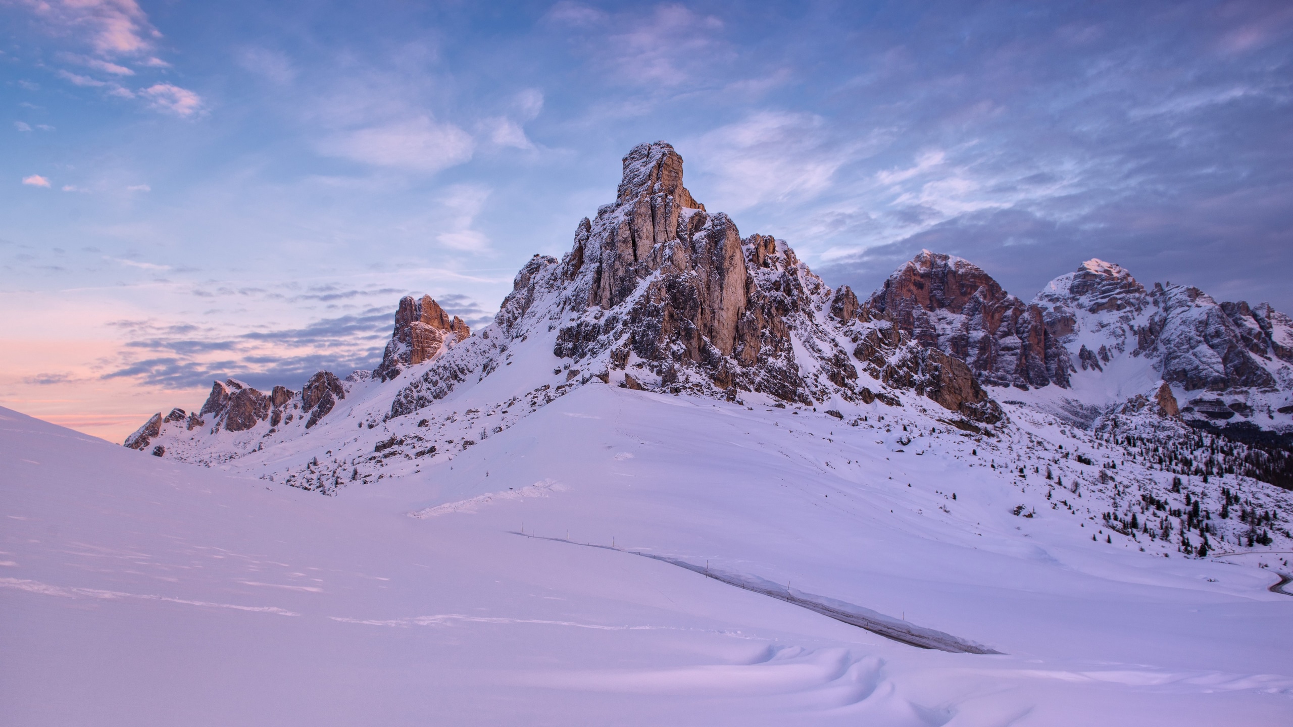 Wallpaper / a snow covered mountain base and a mountain peak touching blue skies, snowy mountain peaks touch the sky 4k wallpaper free download