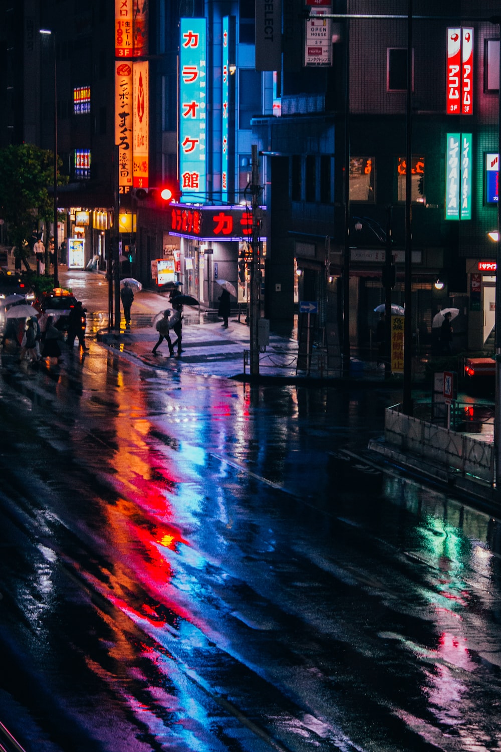 people walking on street during night time photo
