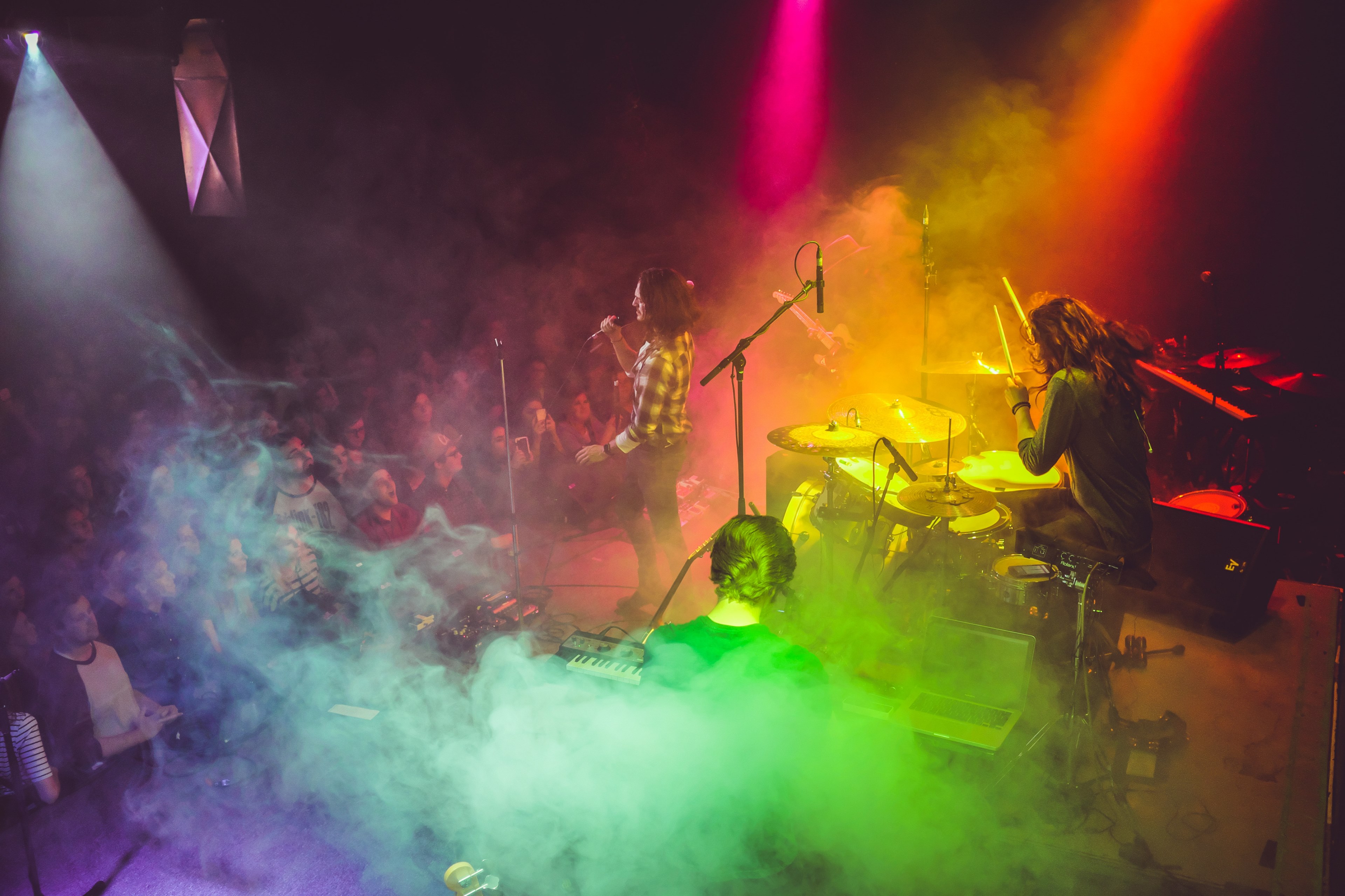 Wallpaper / a band performing on stage with rainbow colored lights flooding them from above, band in rainbow smoke 4k wallpaper free download