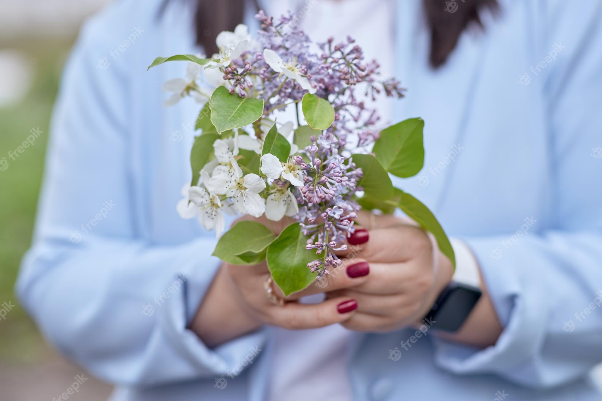 Premium Photo. Aesthetic spring flowers in woman39s hands close up lilac and apricot blooming spring background