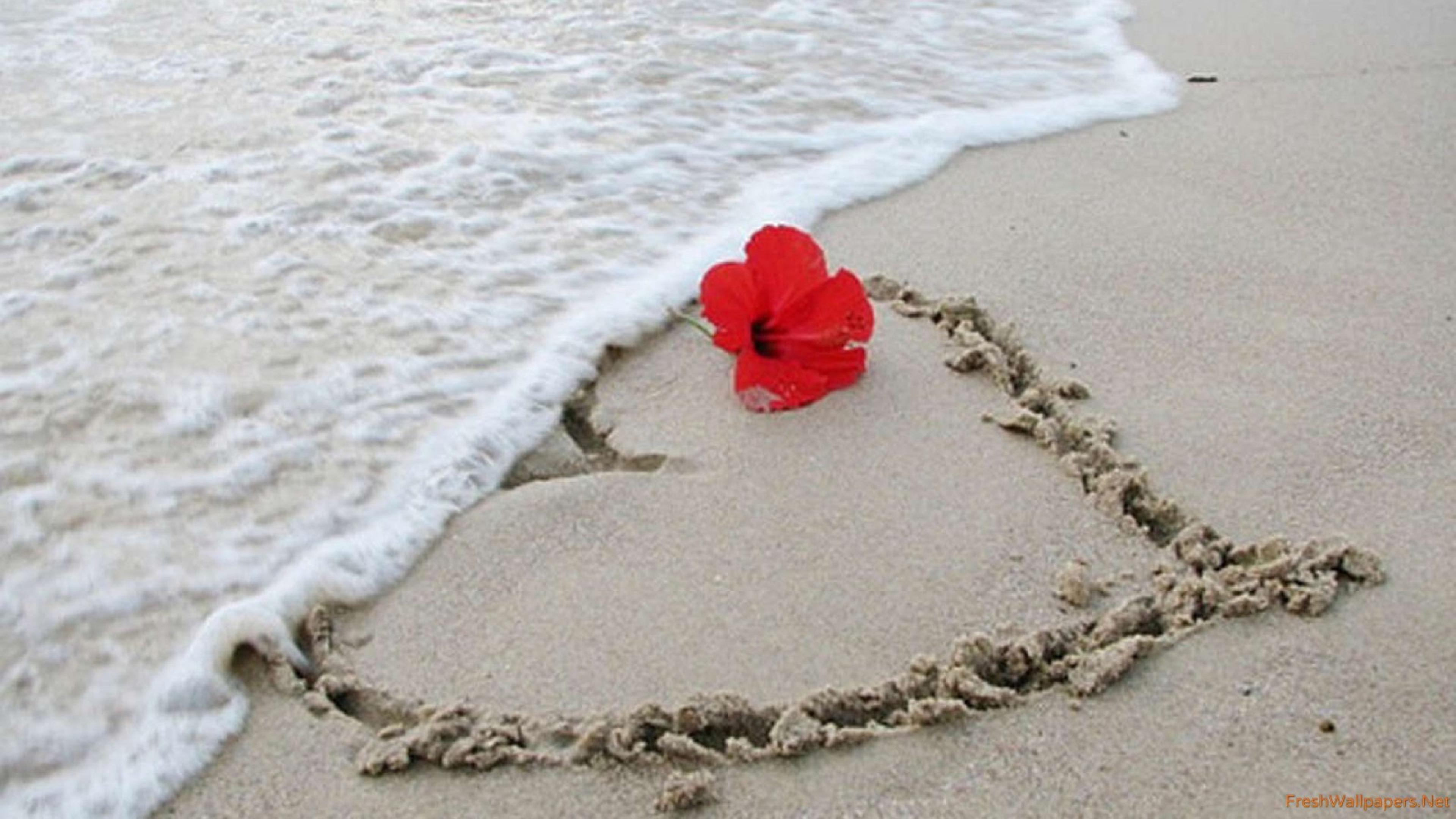 Heart painted in the sand at the beach