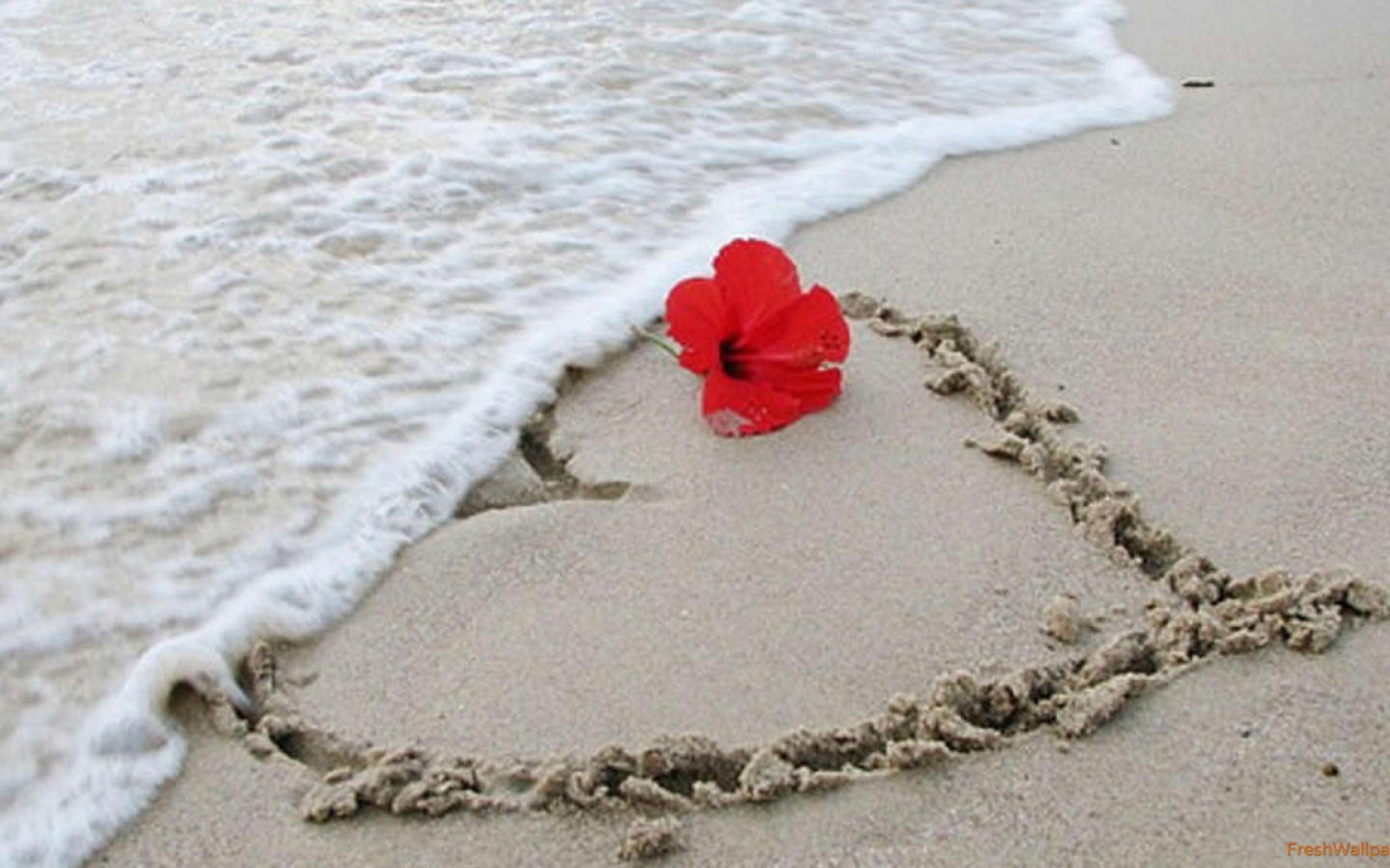 Heart painted in the sand at the beach