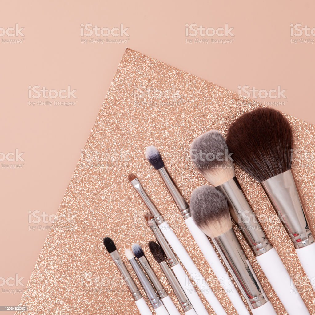Makeup Brush In Flat Lay Style On Soft Glitter Beige And Gold Background Top View Image Now
