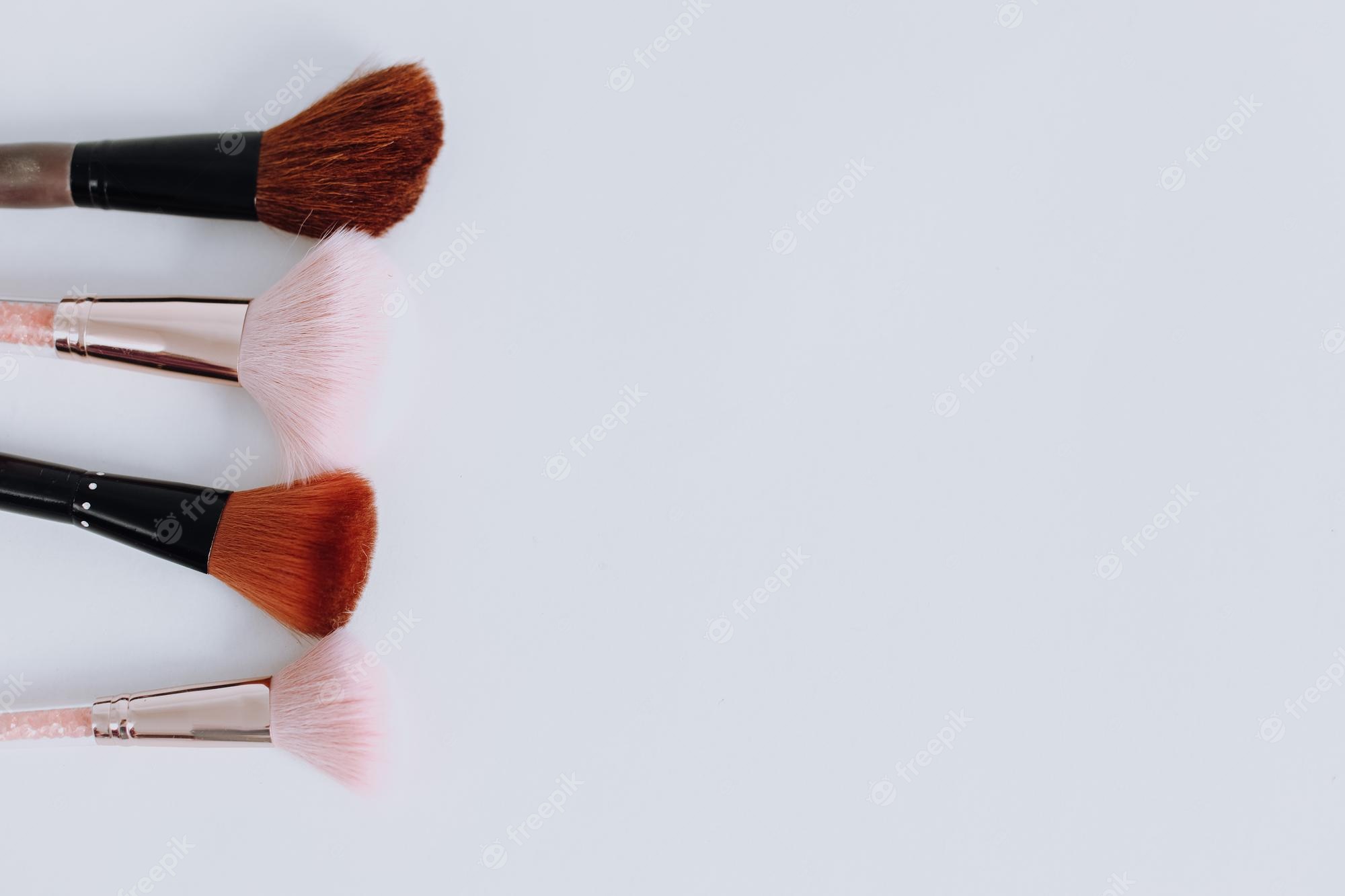Premium Photo. Various makeup brushes arranged over white background with copy space cute girly wallpaper