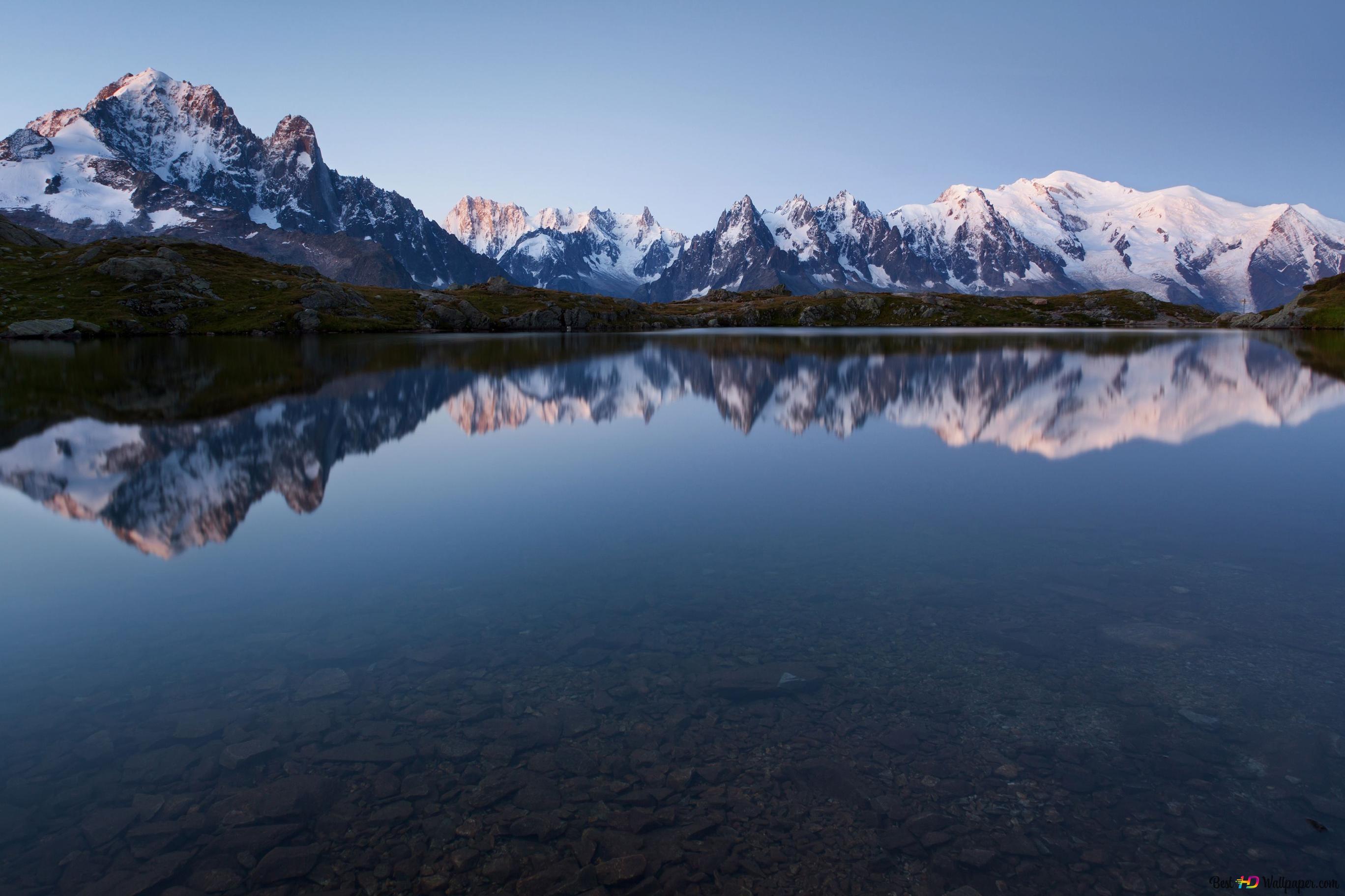 Snowy mountain peaks and clear sky reflection in clear water 4K wallpaper download