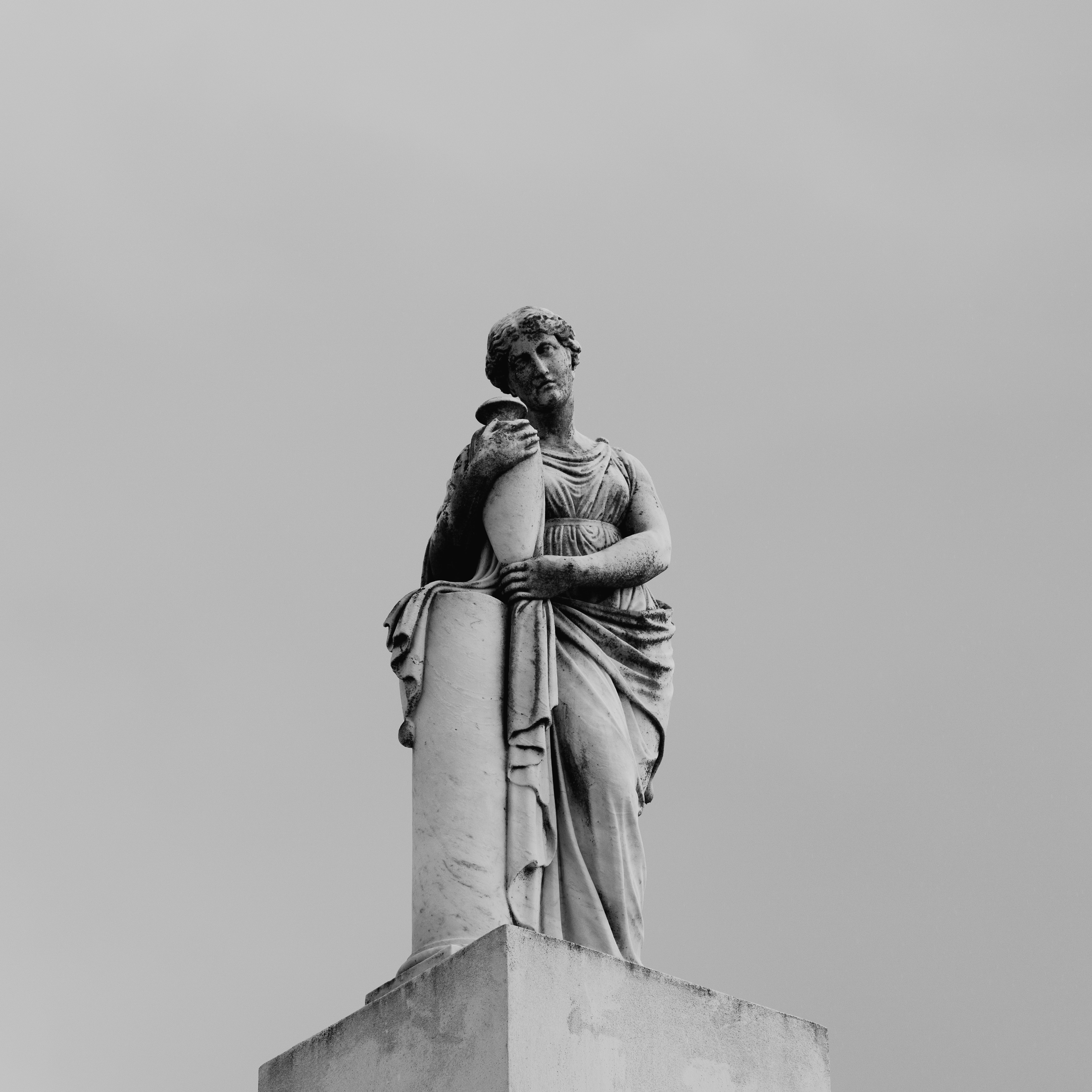 A Marble Statue in Black and White Photo · Free