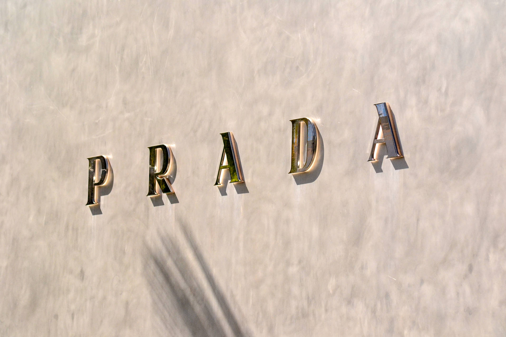 Download Prada Gold Letters On Wall Wallpaper