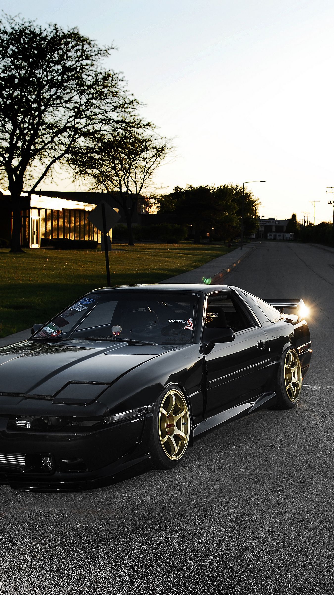 Download wallpaper 1350x2400 toyota, supra, ma61, black, front part, tuning, street, sun, glare iphone 8+/7+/6s+/for parallax HD background