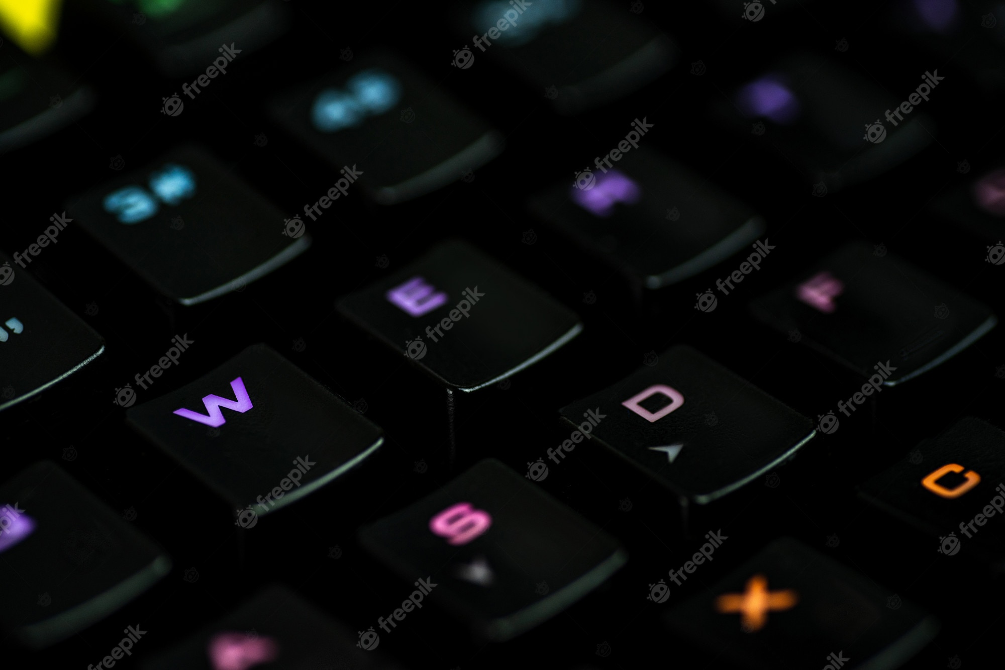 Premium Photo. A Gaming Keyboard With Rgb Color Backlight Shot Closeup On A Black Wall With Space For Text. The Concept Of Games, E Sports And The Workspace Of The Gamer. Top