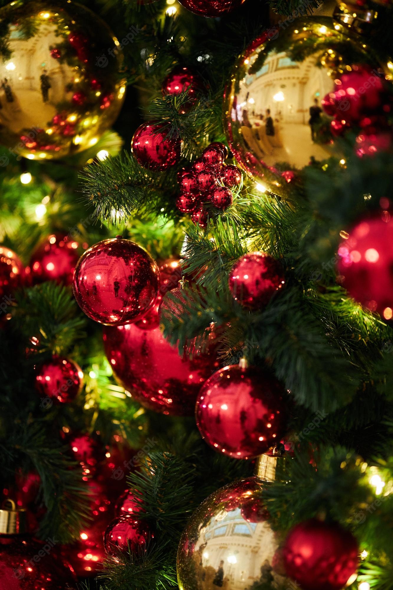 Premium Photo. Red decorative balls festive decoration on the christmas tree new year 2023 2024 decoration