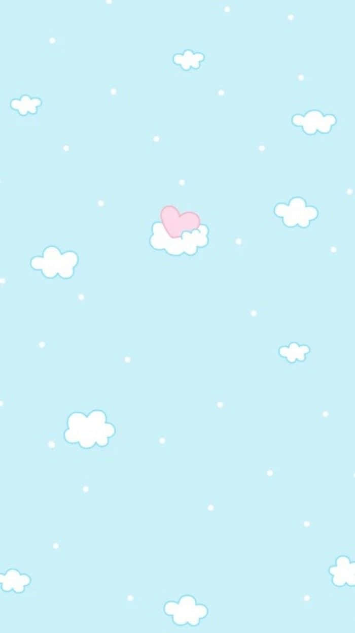 Download A Pink Heart On A Blue Background With Clouds Wallpaper