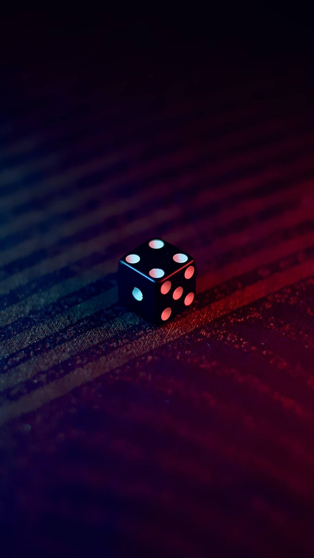 white and black dice on red textile photo