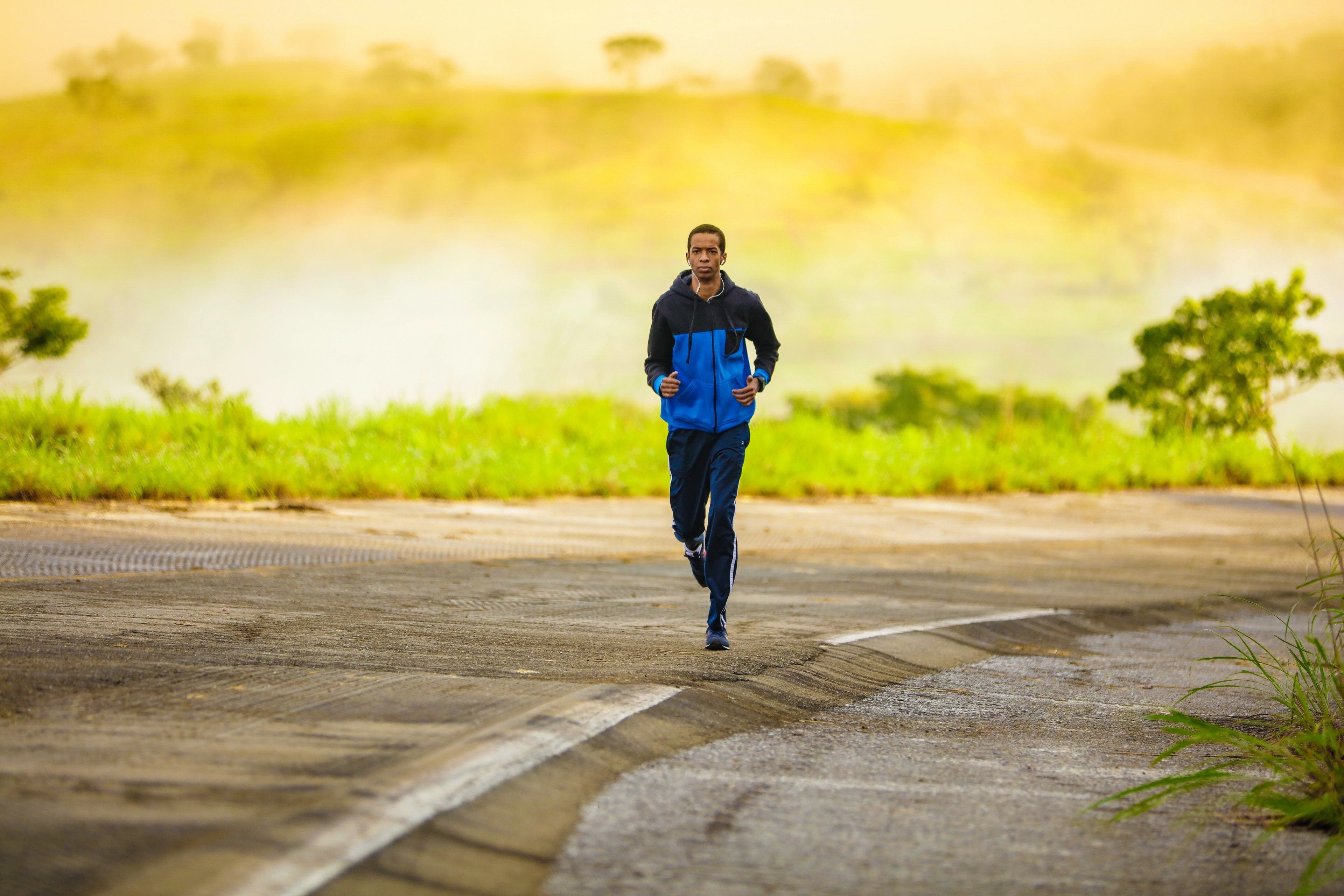 Wallpaper / a male wearing a spring jacket running along the side of the road in brasilia, man running down side of road 4k wallpaper free download