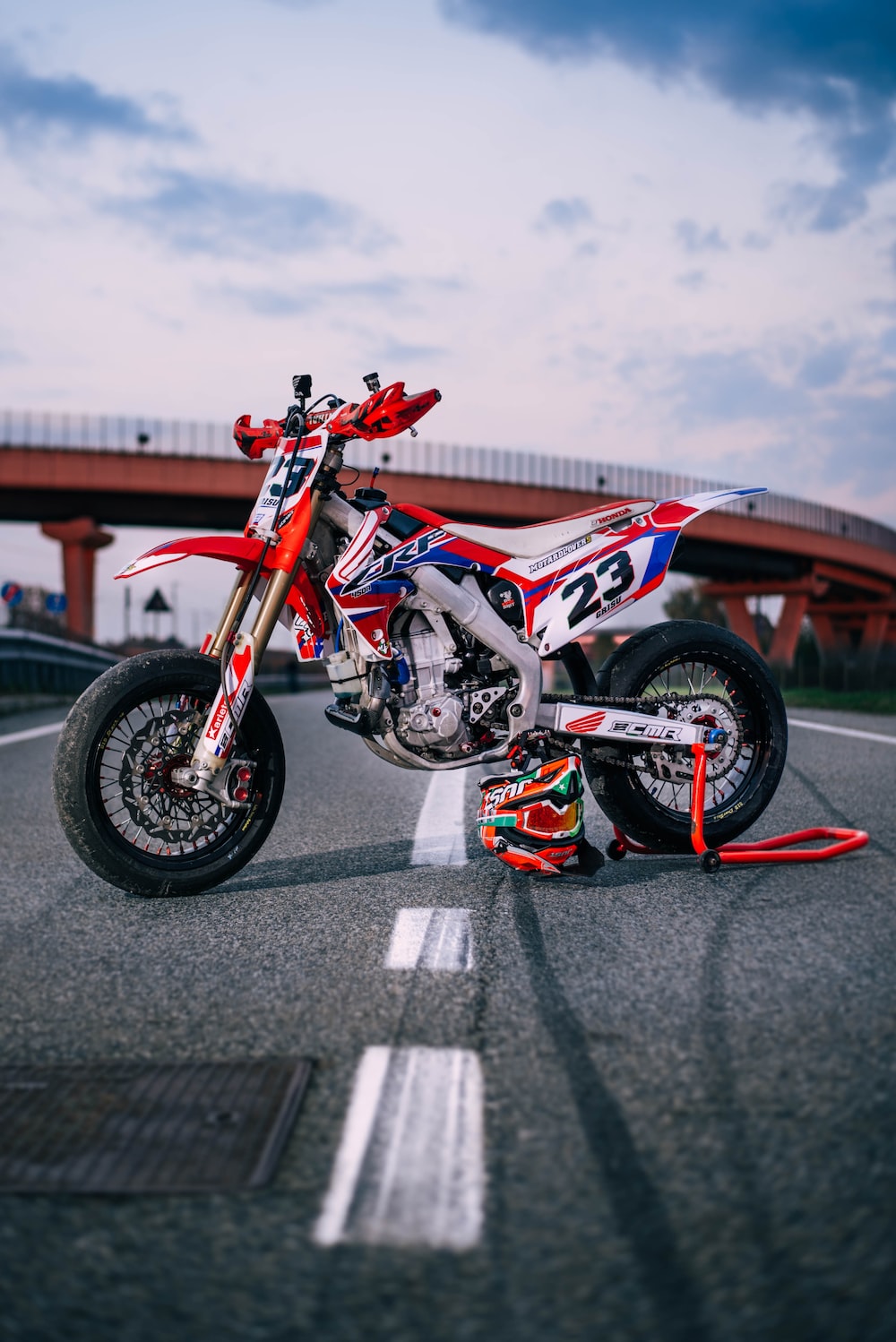 red and black sports bike on road during daytime photo